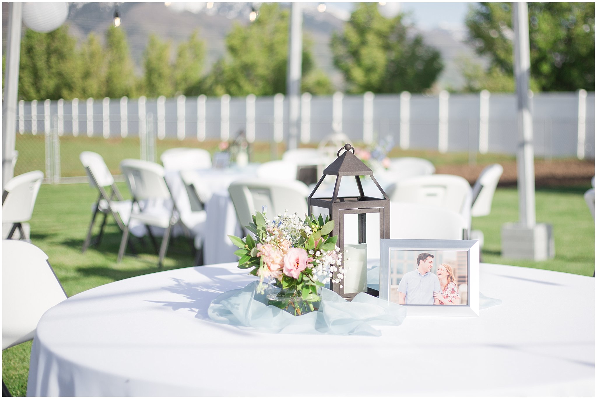 Lantern and flower table setup | Backyard outdoor spring wedding with grey, blush, and light blue wedding colors | Spring Provo City Center Temple Wedding | Utah Wedding Photographers | Jessie and Dallin Photography