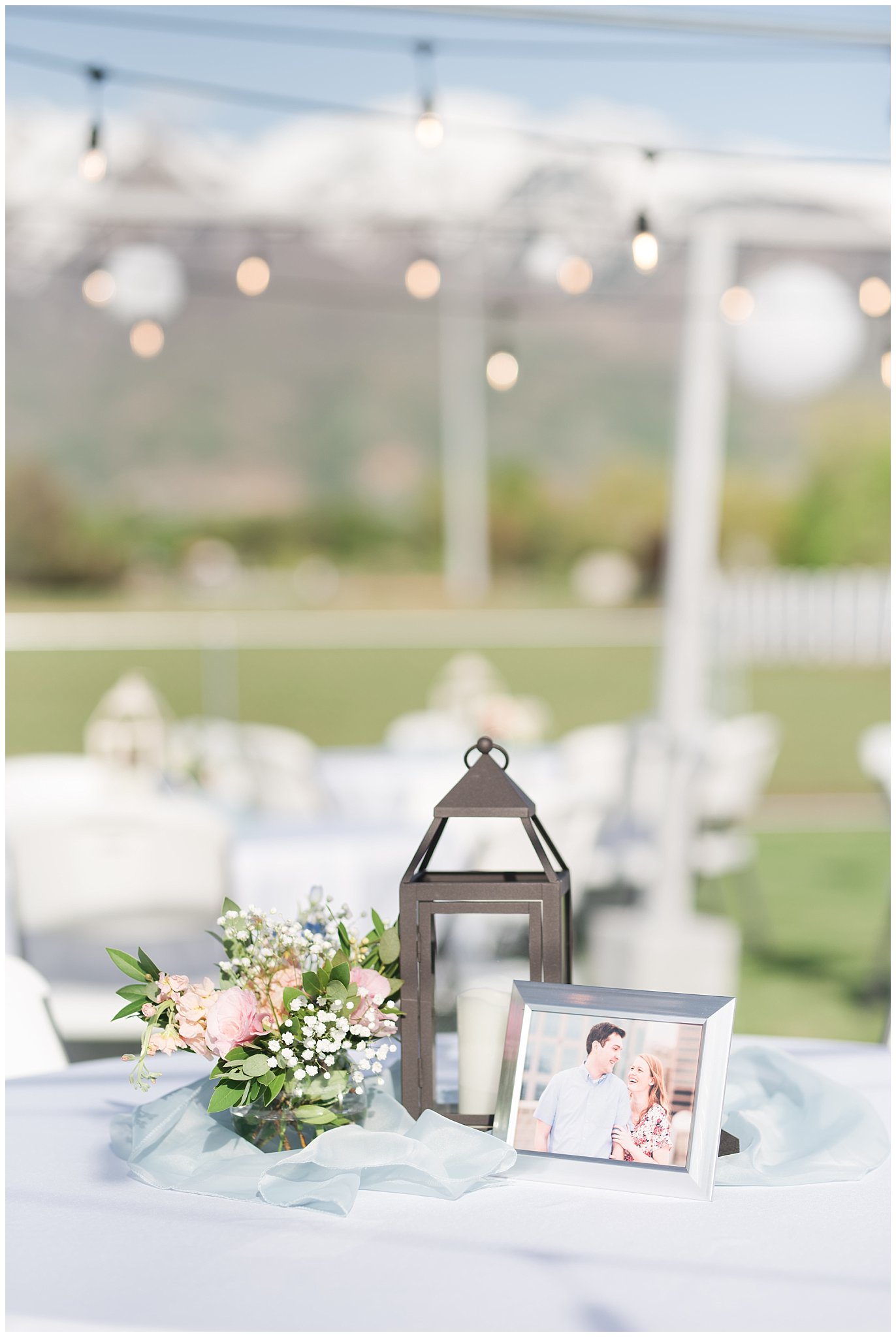 Lantern and flower table setup | Backyard outdoor spring wedding with grey, blush, and light blue wedding colors | Spring Provo City Center Temple Wedding | Utah Wedding Photographers | Jessie and Dallin Photography