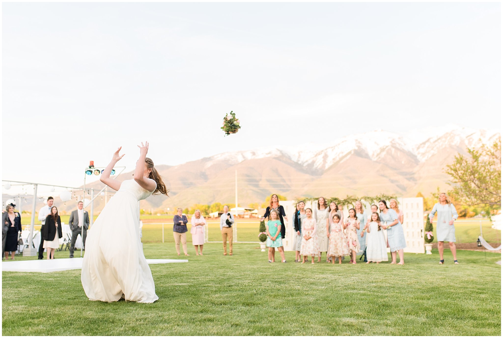 Bouquet toss outdoors | Backyard outdoor spring wedding with grey, blush, and light blue wedding colors | Spring Provo City Center Temple Wedding | Utah Wedding Photographers | Jessie and Dallin Photography