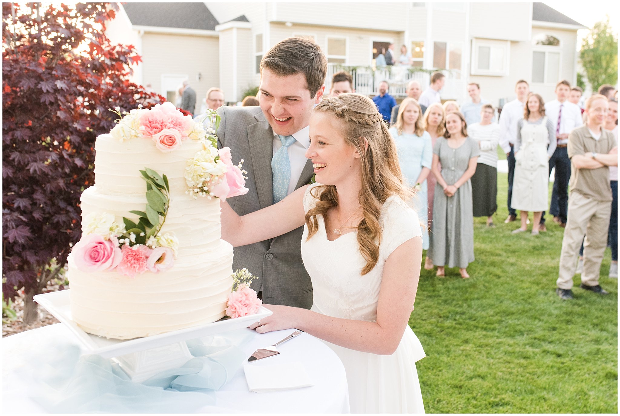 Bride and groom cake cutting | Backyard outdoor spring wedding with grey, blush, and light blue wedding colors | Spring Provo City Center Temple Wedding | Utah Wedding Photographers | Jessie and Dallin Photography