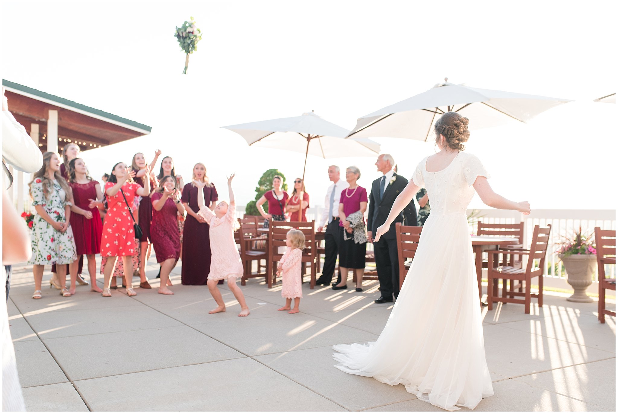 Bouquet toss at reception | Grey, Burgundy, and Gold Wedding | Draper Temple and South Mountain Wedding | Utah Wedding Photographers | Jessie and Dallin Photography