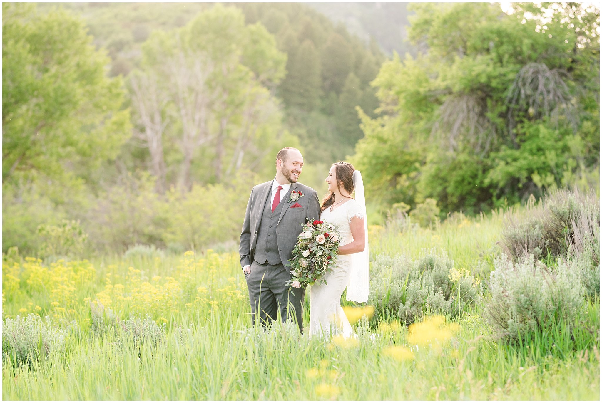 Bride and groom portraits in the mountains | Groom in grey suit and bride in beige and white dress with waterfall bouquet | Snowbasin Summer Formal Session | Utah Wedding Photographers | Jessie and Dallin