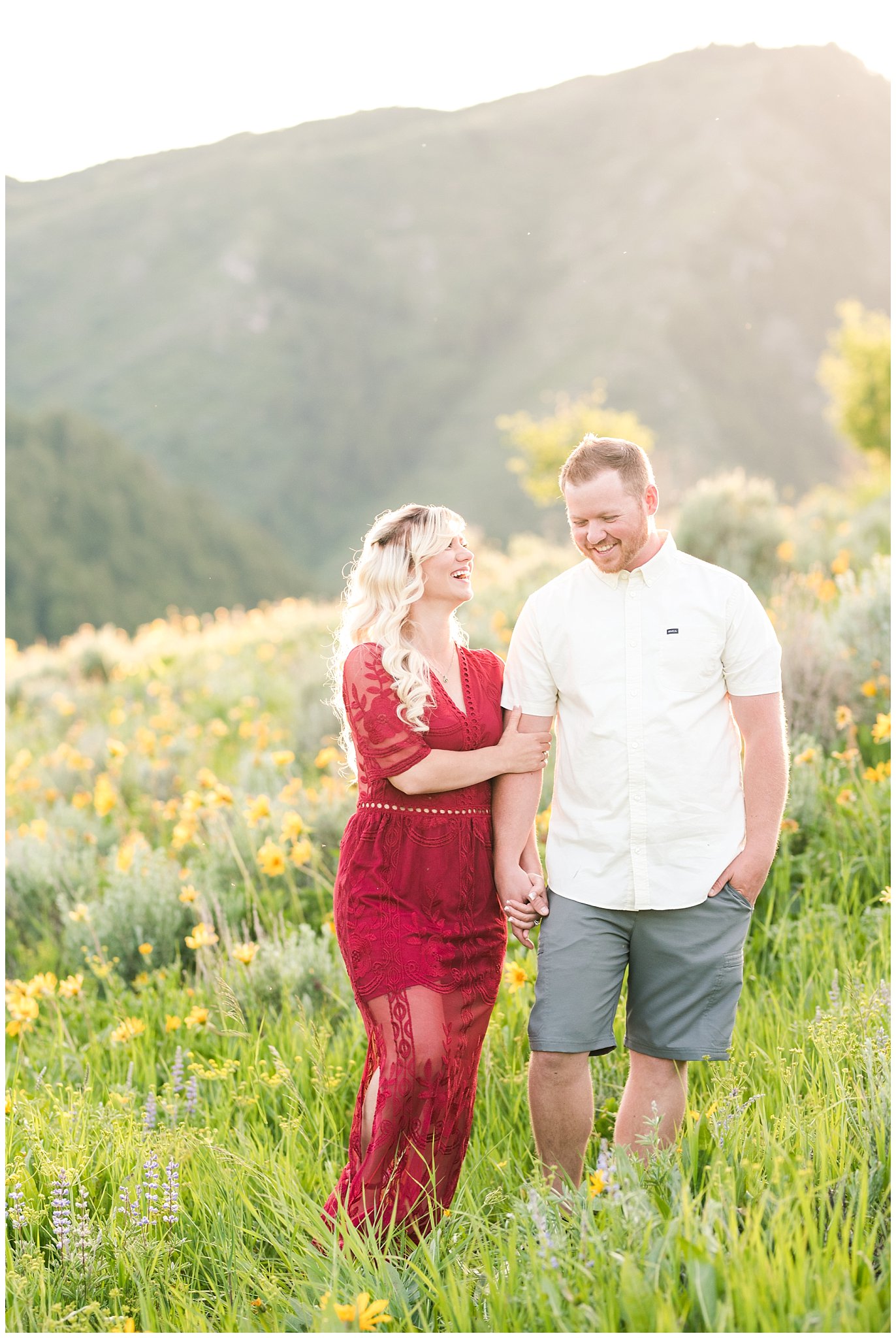 Couple in red lace dress in the sunflowers with mountain peaks | Wildflower Engagement in the Utah Mountains | Utah Engagement Photography | Jessie and Dallin Photography