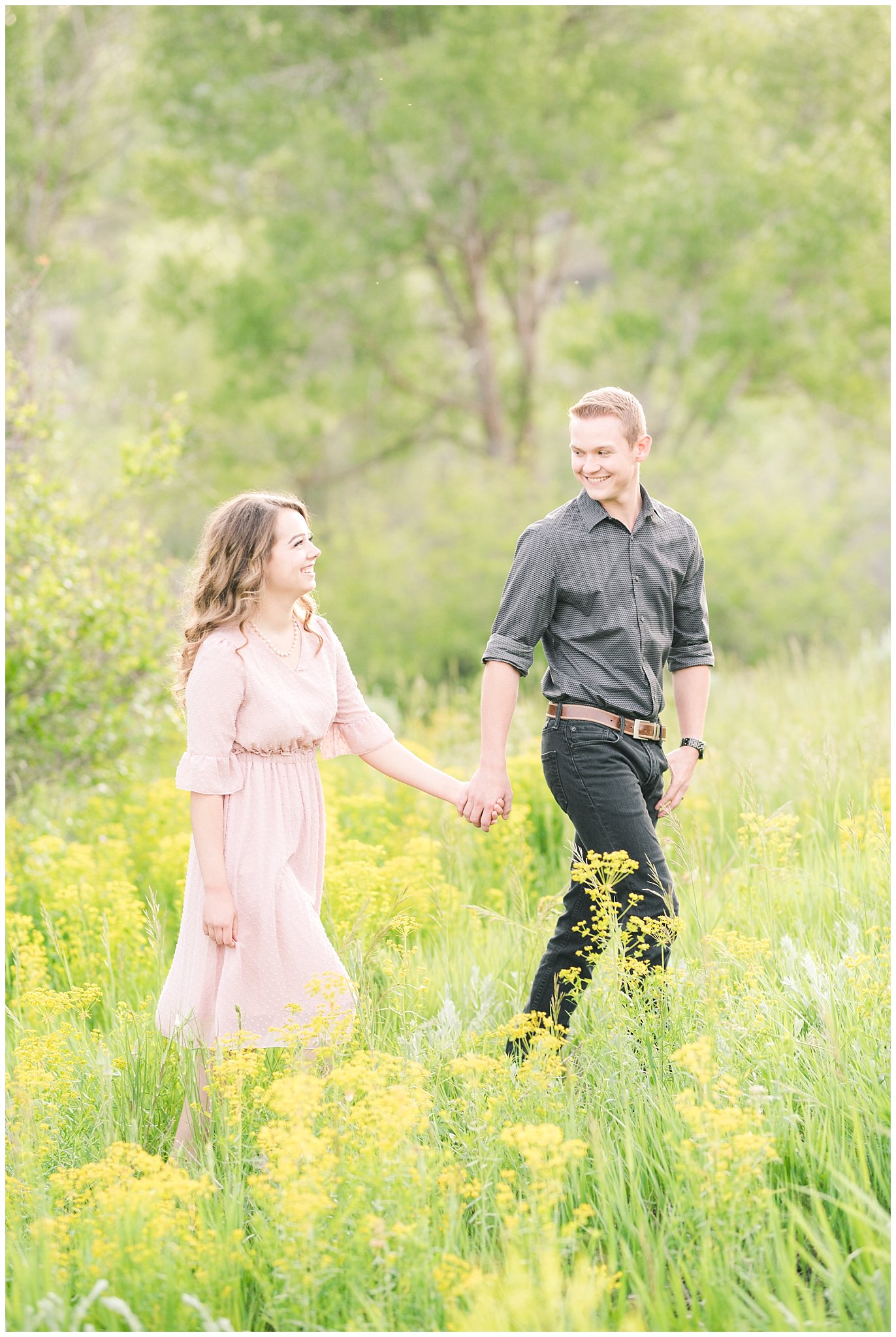 Couple in blush dress and grey and black buttoned shirt in a wooded meadow | Trapper's Loop Mountain Engagement | Utah Mountain Engagement Session | Jessie and Dallin Photography