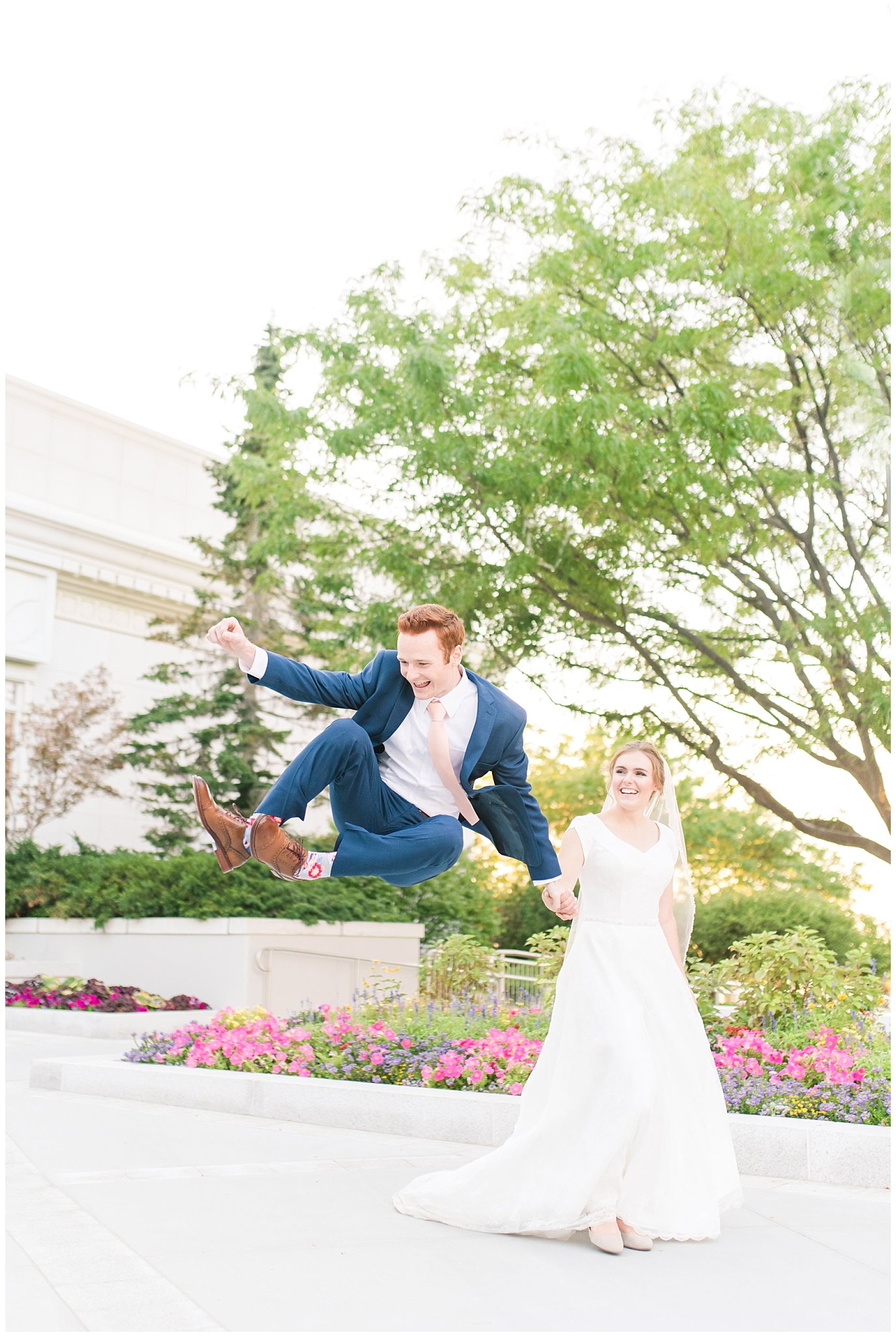 Groom heel click with bride | Bride and groom portraits with bride in simple elegant dress and veil, and groom in blue suit with blush tie at the Bountiful Temple | Bountiful Temple Summer Formal Session | Utah Weddings | Jessie and Dallin Photography