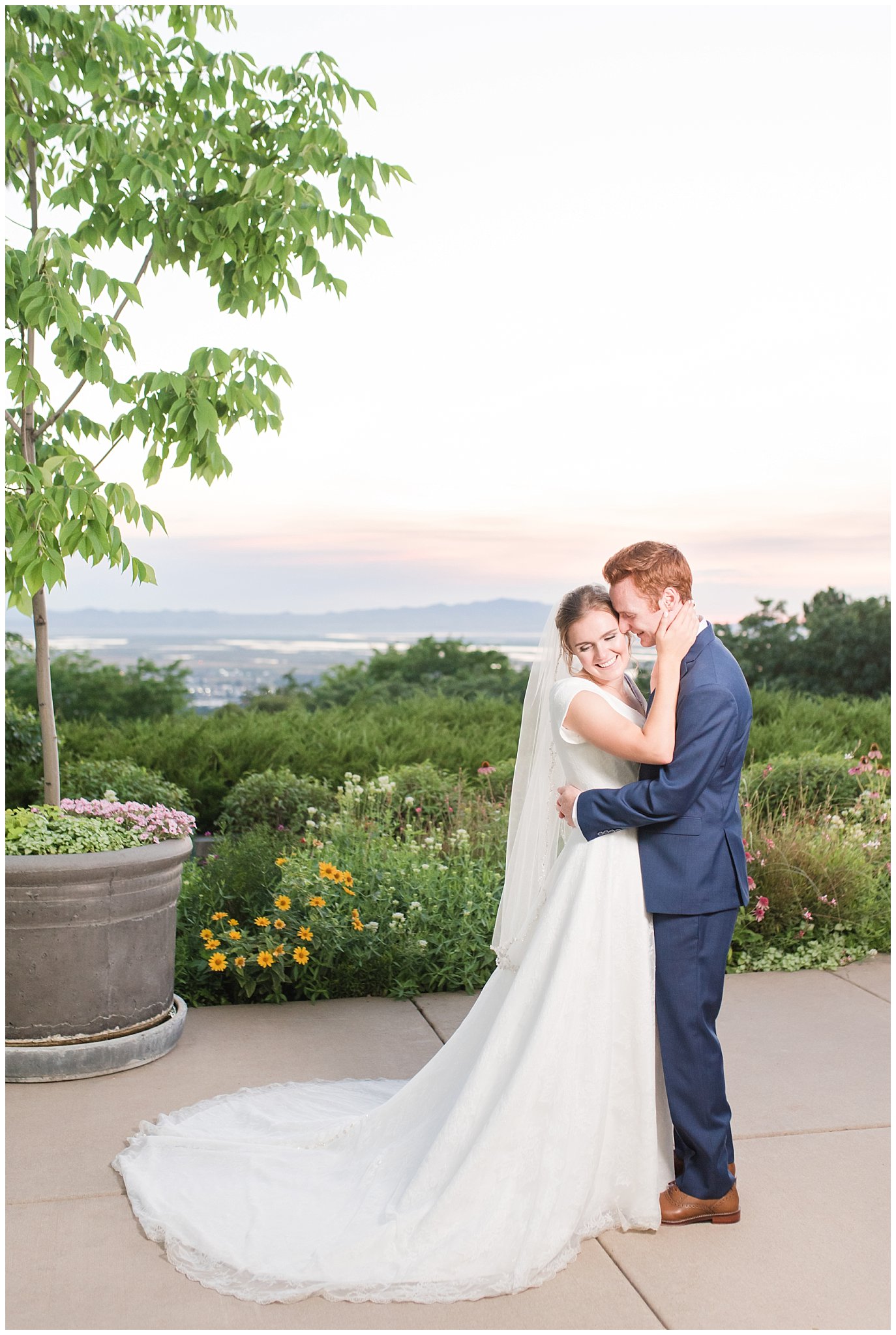 Bride and groom sunset portraits with bride in simple elegant dress and veil, and groom in blue suit with blush tie at the Bountiful Temple | Bountiful Temple Summer Formal Session | Utah Weddings | Jessie and Dallin Photography