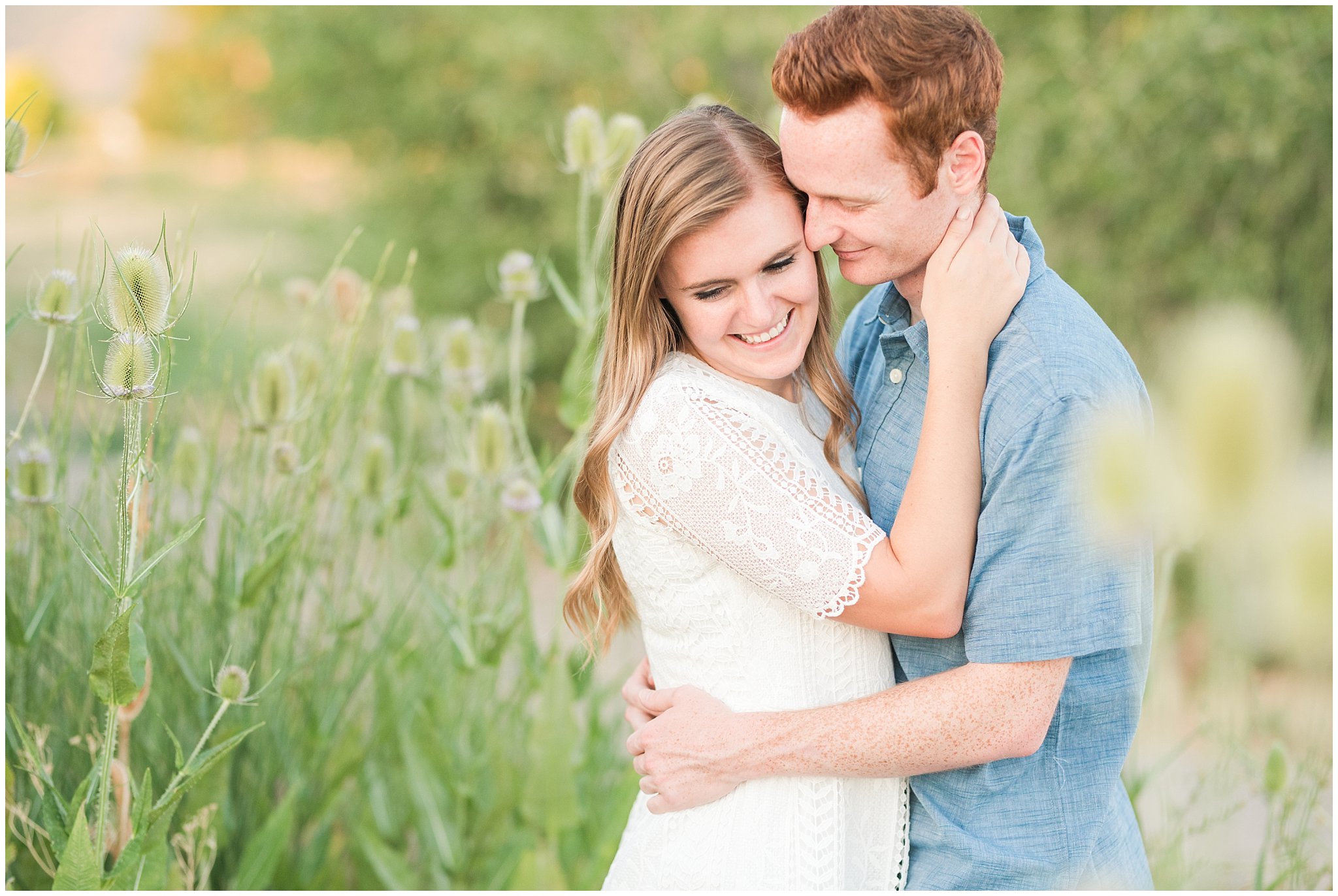 Couple wearing a white lace dress and light blue shirt during candid engagement photos in at a pond with a dock | Kaysville Botanical Garden Engagement | Utah Engagement | Jessie and Dallin Photography