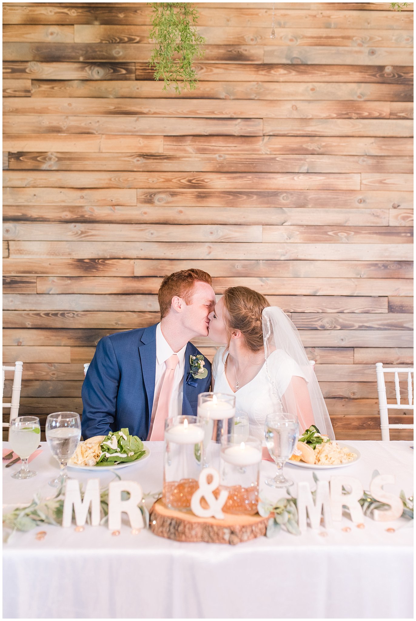 Bride and groom kiss at sweetheart table | Oak Hills Reception and Events Center | Jessie and Dallin Photography