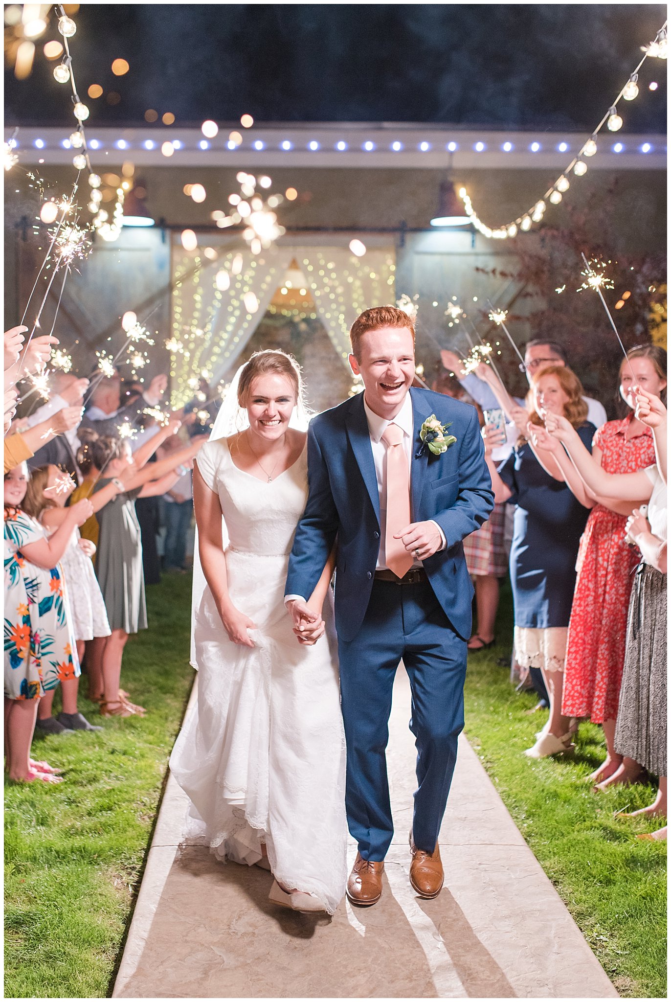 Sparkler exit sendoff with hanging string lights above bride and groom | Oak Hills Reception and Events Center | Jessie and Dallin Photography