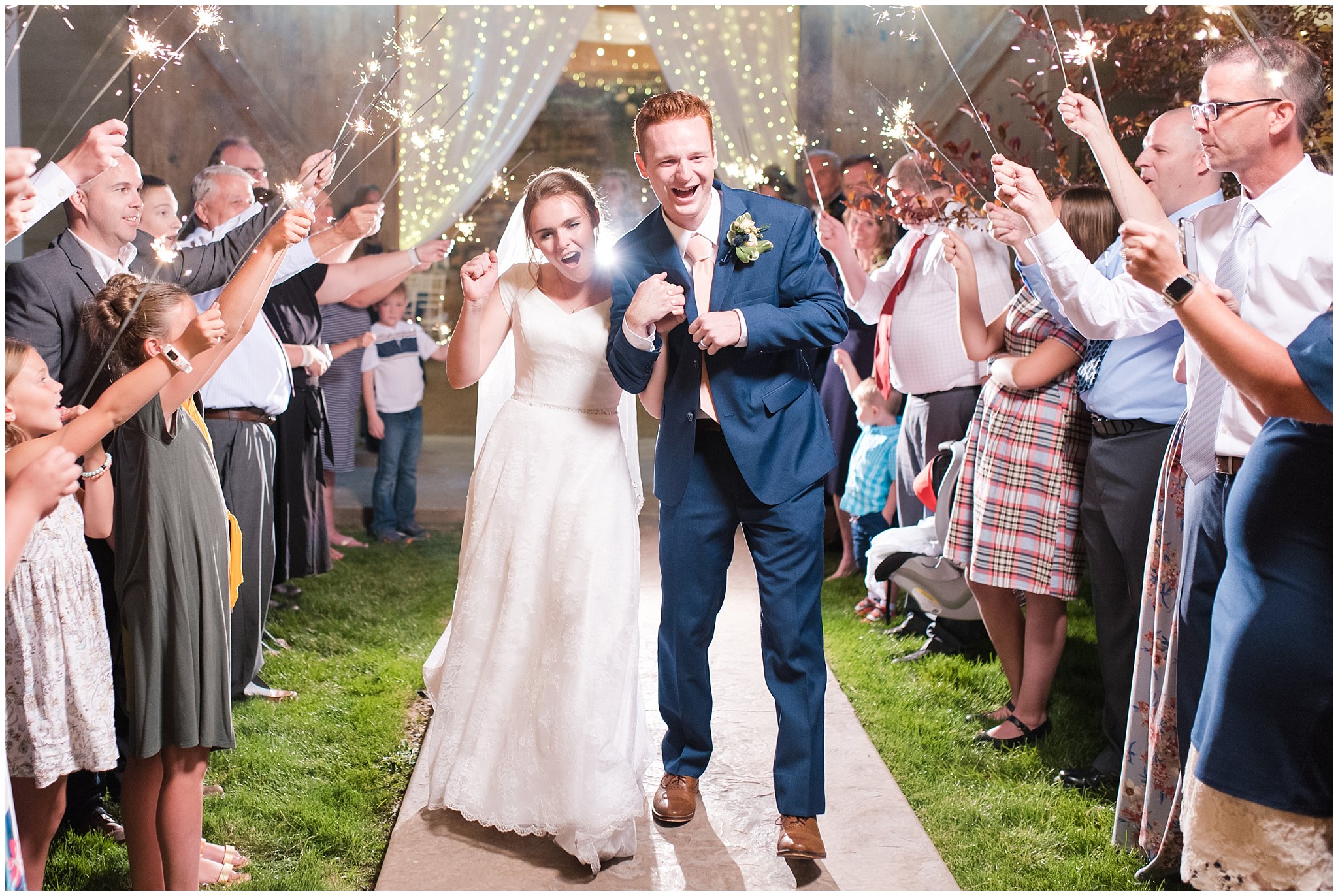Sparkler exit sendoff with hanging string lights above bride and groom | Oak Hills Reception and Events Center | Jessie and Dallin Photography