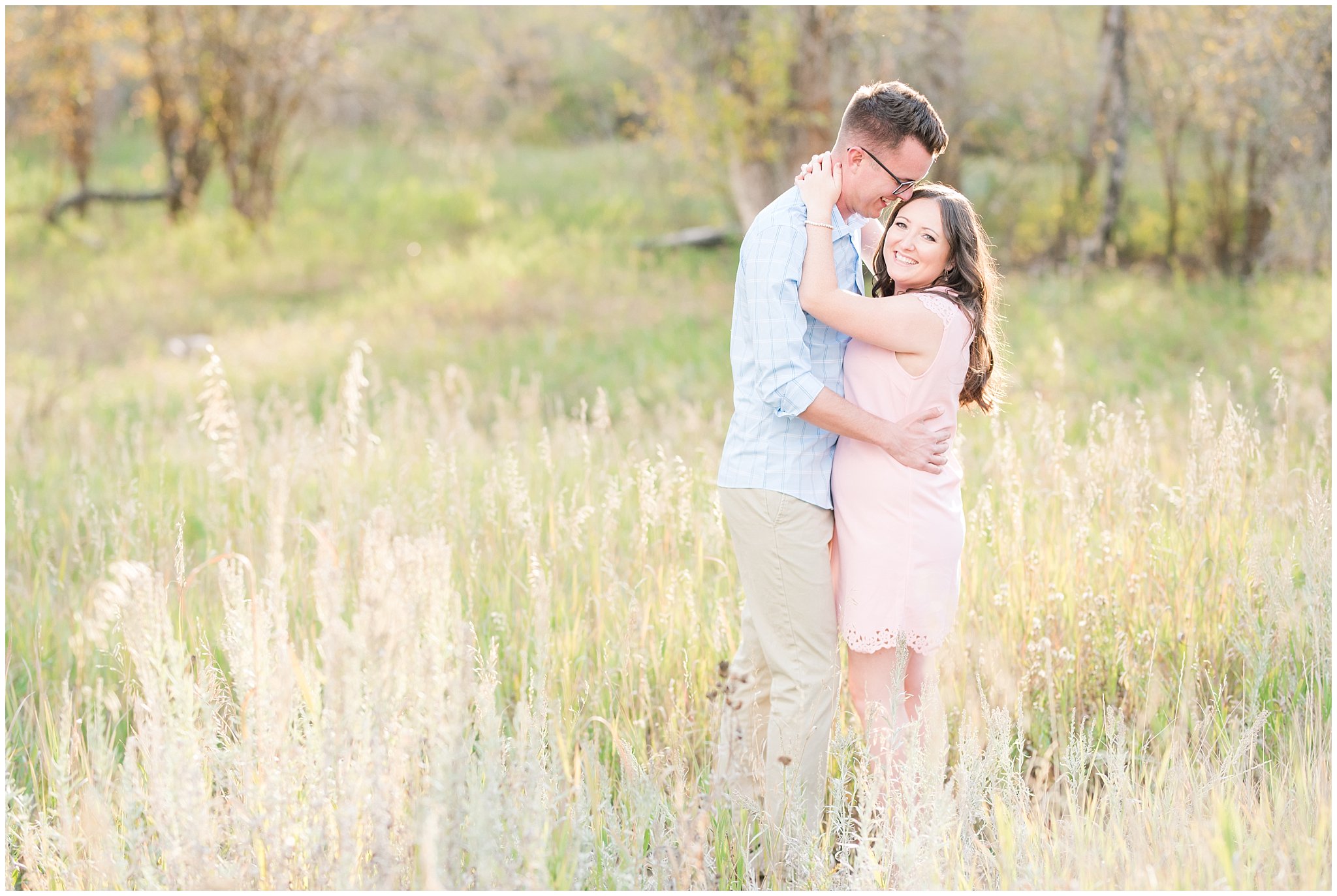 Couple in light blue shirt, tan pants and blush dress | Snowbasin woods and fall trees | A Classic Snowbasin Fall Engagement Session | Jessie and Dallin Photography