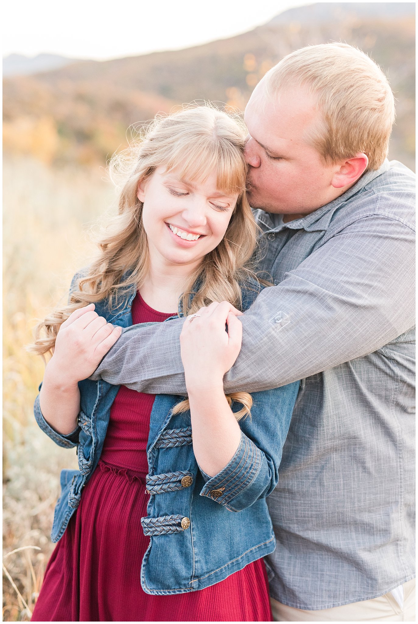 Couple dressed up with girl in burgundy dress with jean jacket and guy in grey shirt and light colored pants | Mountain engagement | Trapper's Loop Fall Engagement Session | Snowbasin Utah Mountains | Jessie and Dallin Photography