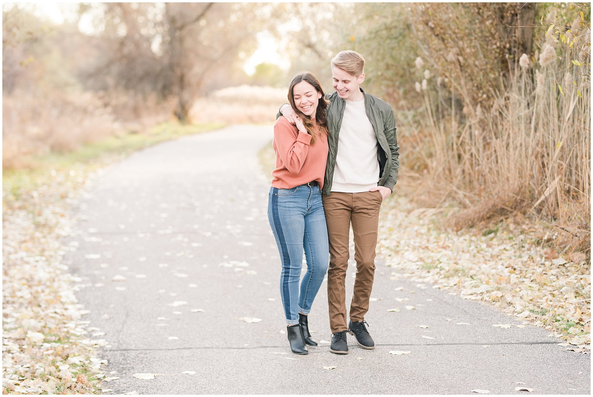 Couple dressed in fall colored sweater, jacket, jeans and boots in a meadow | Kays Creek Parkway Fall Engagement Session | Utah Fall Engagement | Jessie and Dallin Photography