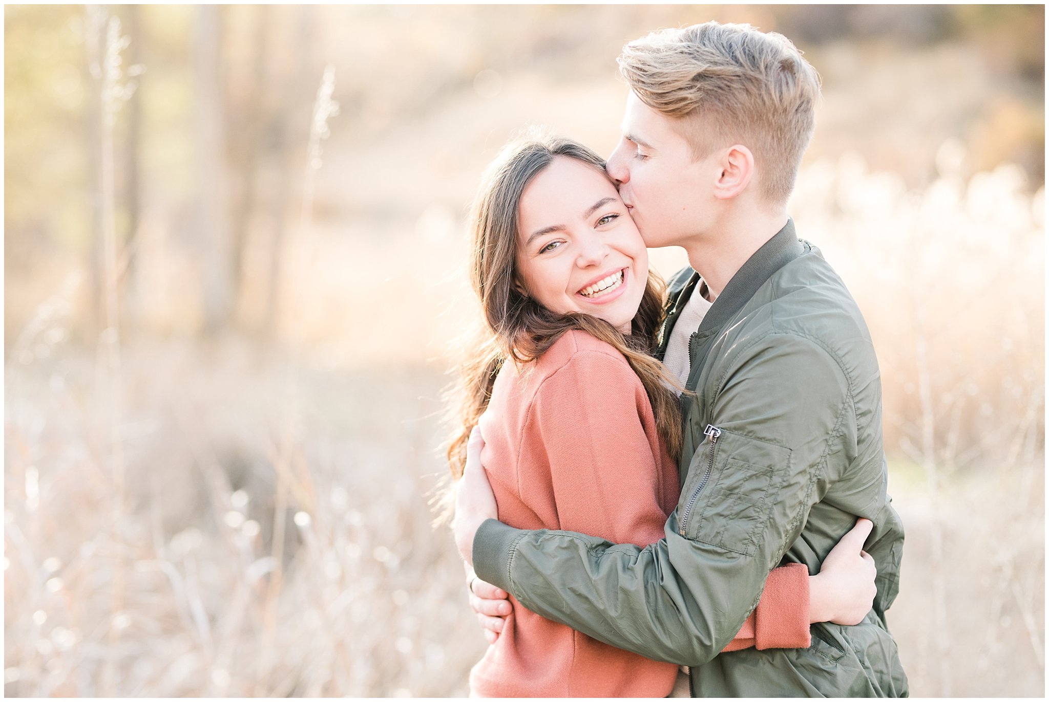 Couple dressed in fall colored sweater, jacket, jeans and boots in a meadow | Kays Creek Parkway Fall Engagement Session | Utah Fall Engagement | Jessie and Dallin Photography