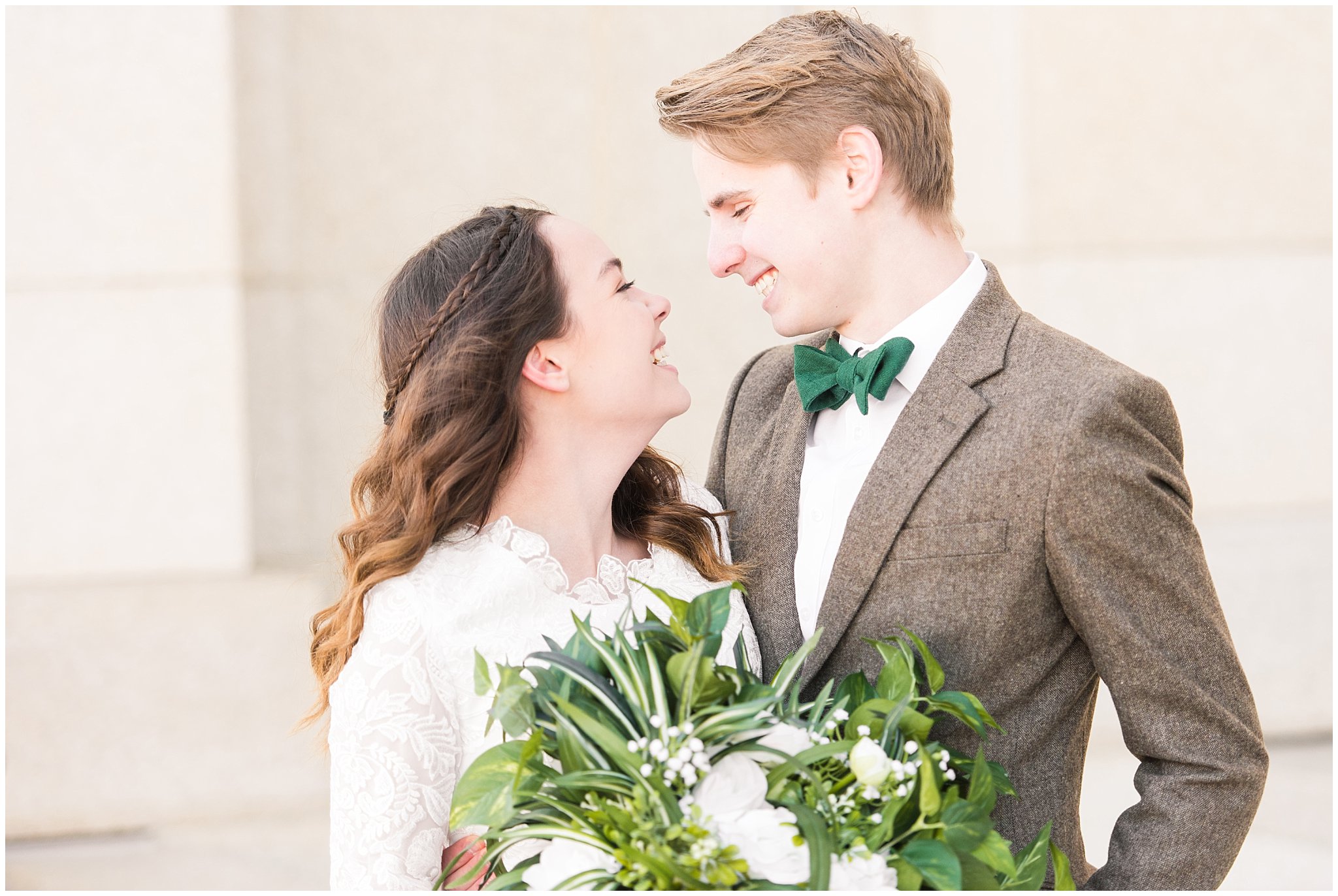 Bride in lace draping dress and groom in brown tweed suit with green and white florals | Ogden Temple Winter Formal Session | Jessie and Dallin Photography