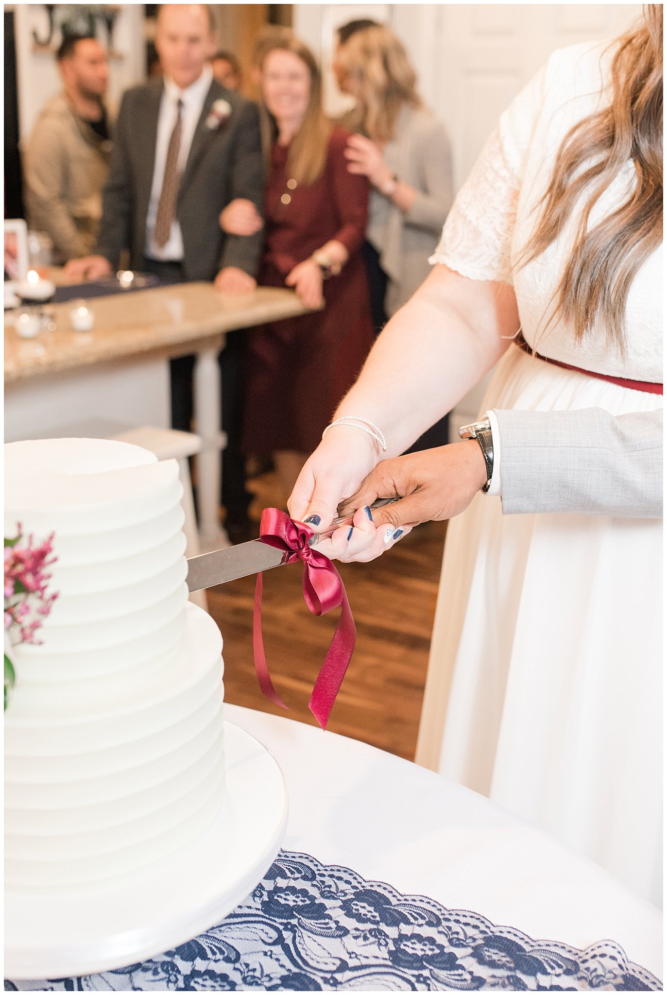 Bride and groom cutting cake by Sweet Cravings at reception | Jordan River Temple Winter wedding and reception | Jessie and Dallin Photography