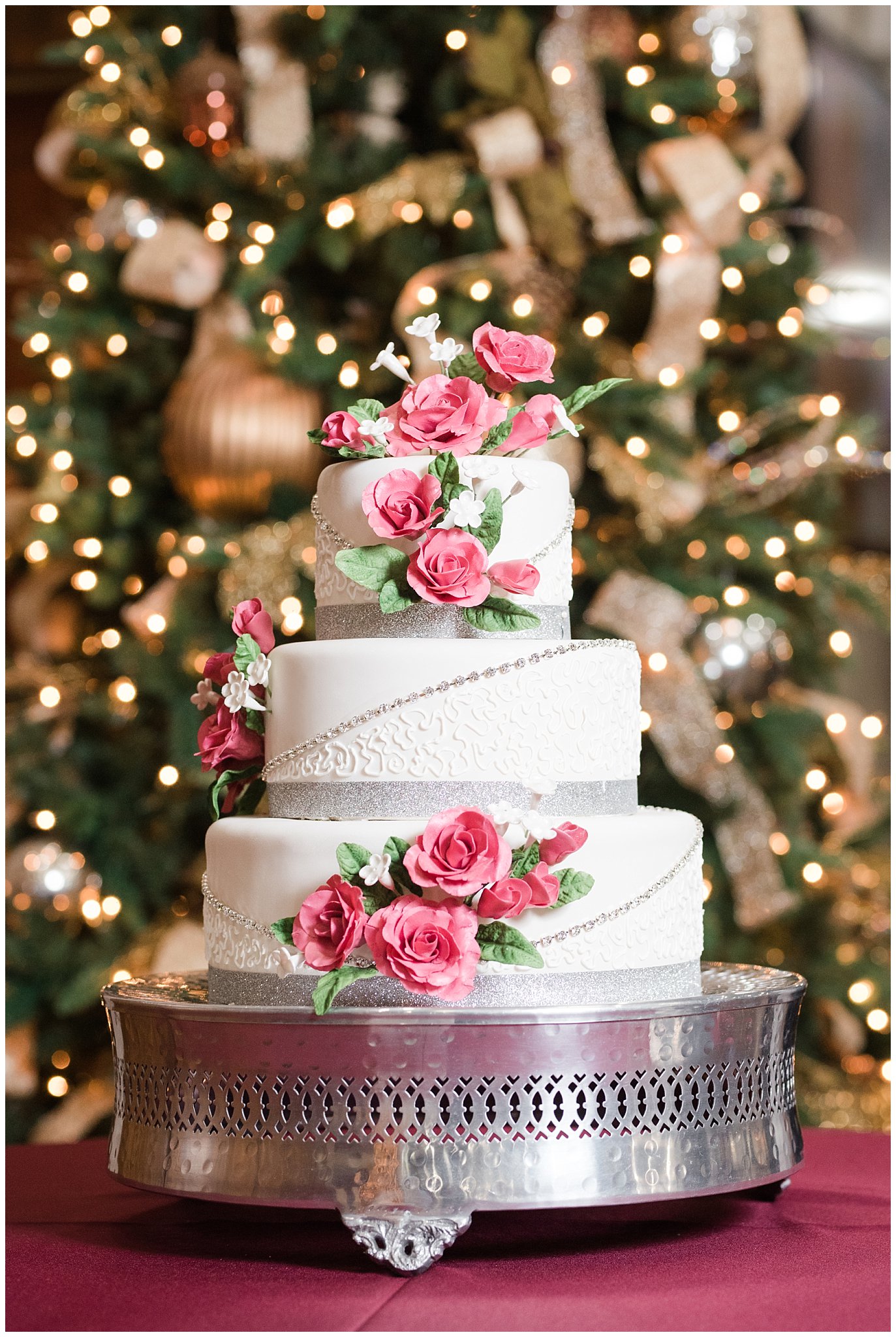 White and silver wedding cake with pink sugar flowers at the Gathering Place at Gardner Village | Oquirrh Mountain Temple and Gardner Village Wedding | The Gathering Place | Jessie and Dallin Photography