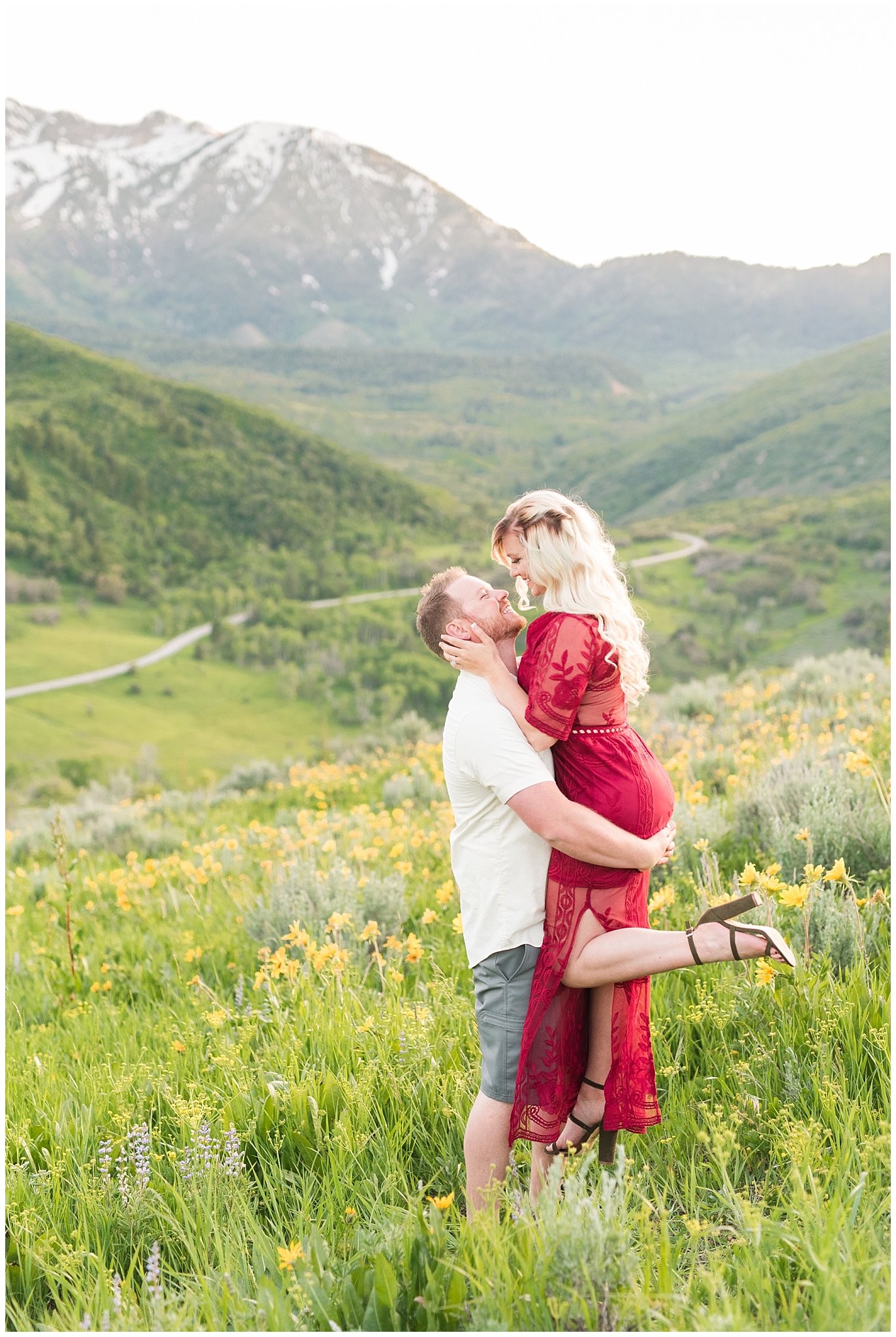 Couple does romantic lift in the wildflowers in front of snow capped Utah mountains | Top Utah Wedding and Couples Photos 2019 | Jessie and Dallin Photography