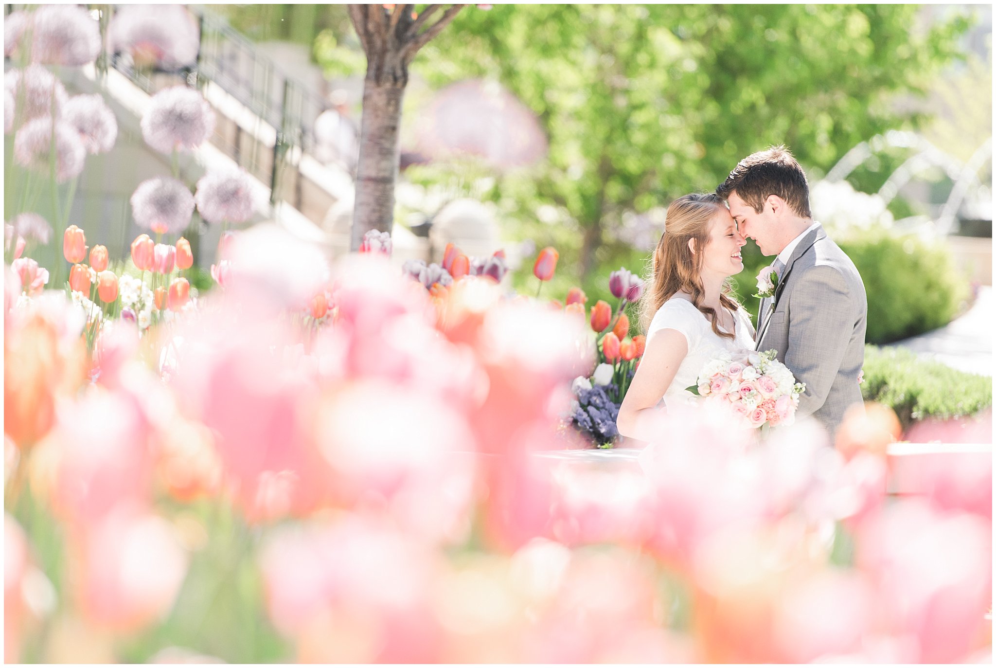 Bride and groom stand near tulip garden at the Provo City Center Temple | Top Utah Wedding and Couples Photos 2019 | Jessie and Dallin Photography