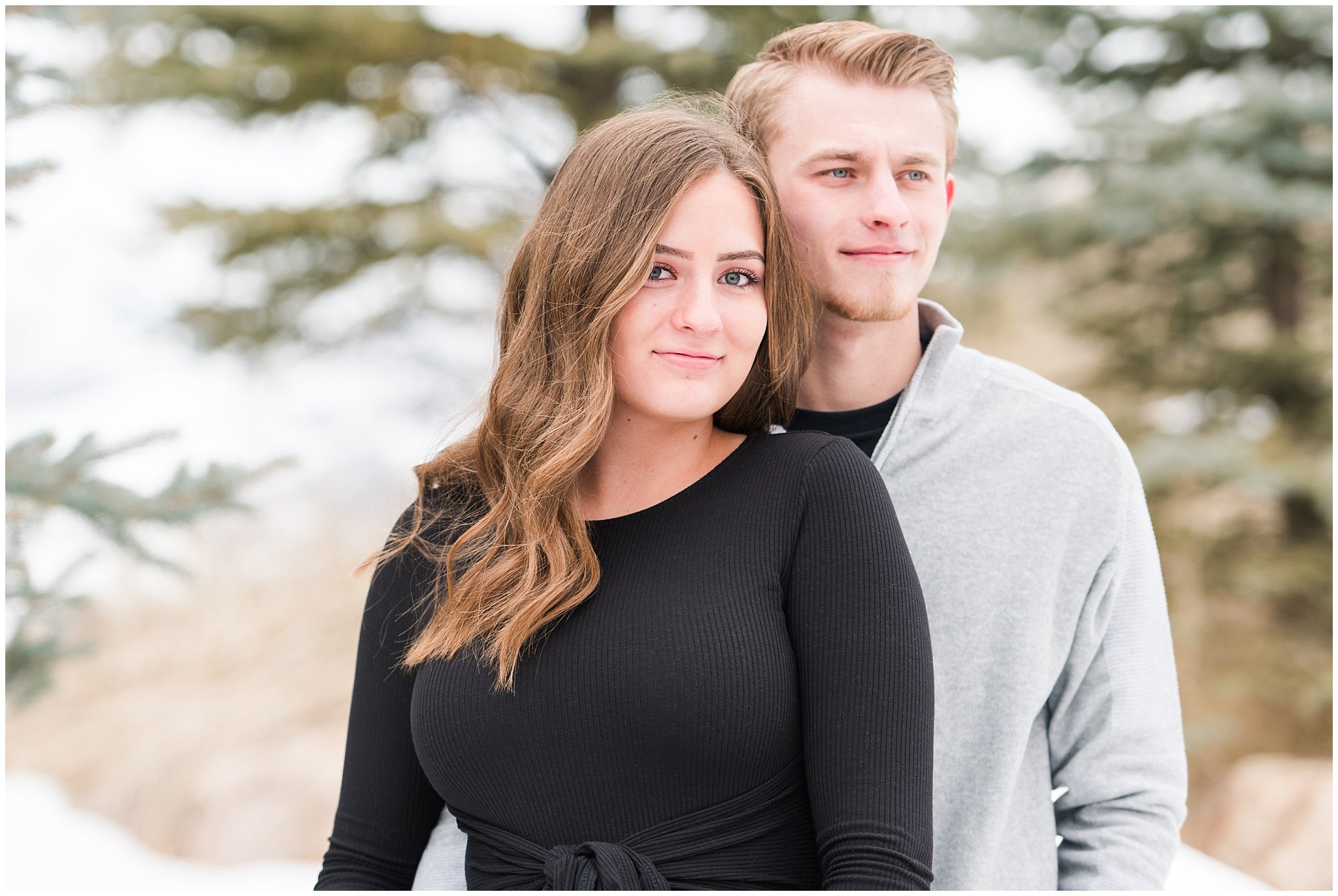 Couple dressed in black dress and grey sweater for engagements in the snowy Utah mountains | Mountain Green Winter Engagement | Jessie and Dallin Photography