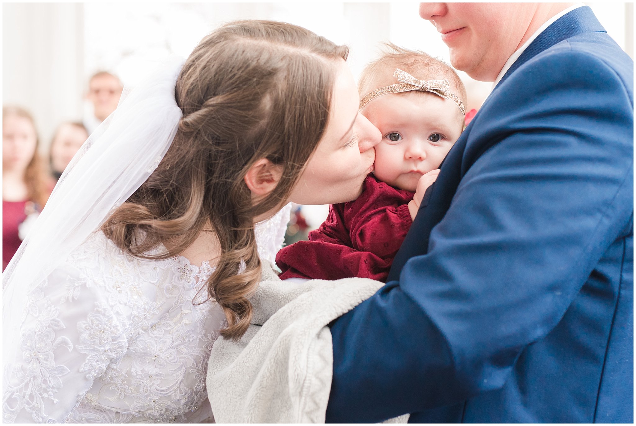 Bride and groom exit the temple with blue suit and burgundy, white and succulent bouquet during winter wedding | Bountiful Temple Wedding and Joseph Smith Memorial Reception | Jessie and Dallin Photography