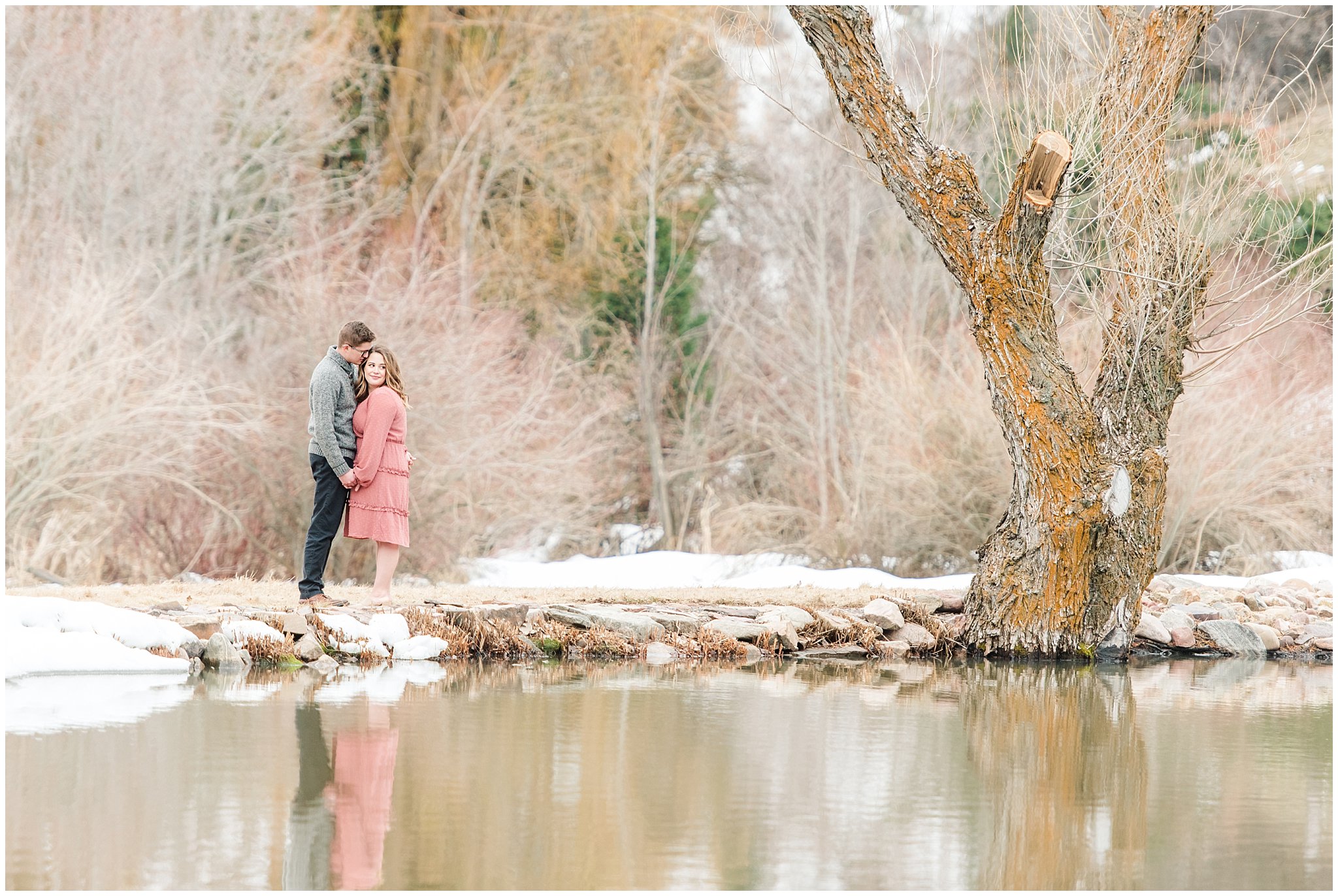 Couple in salmon colored dress and grey sweater during winter mountain engagements | Trapper's Loop Winter Engagement | Jessie and Dallin Photography