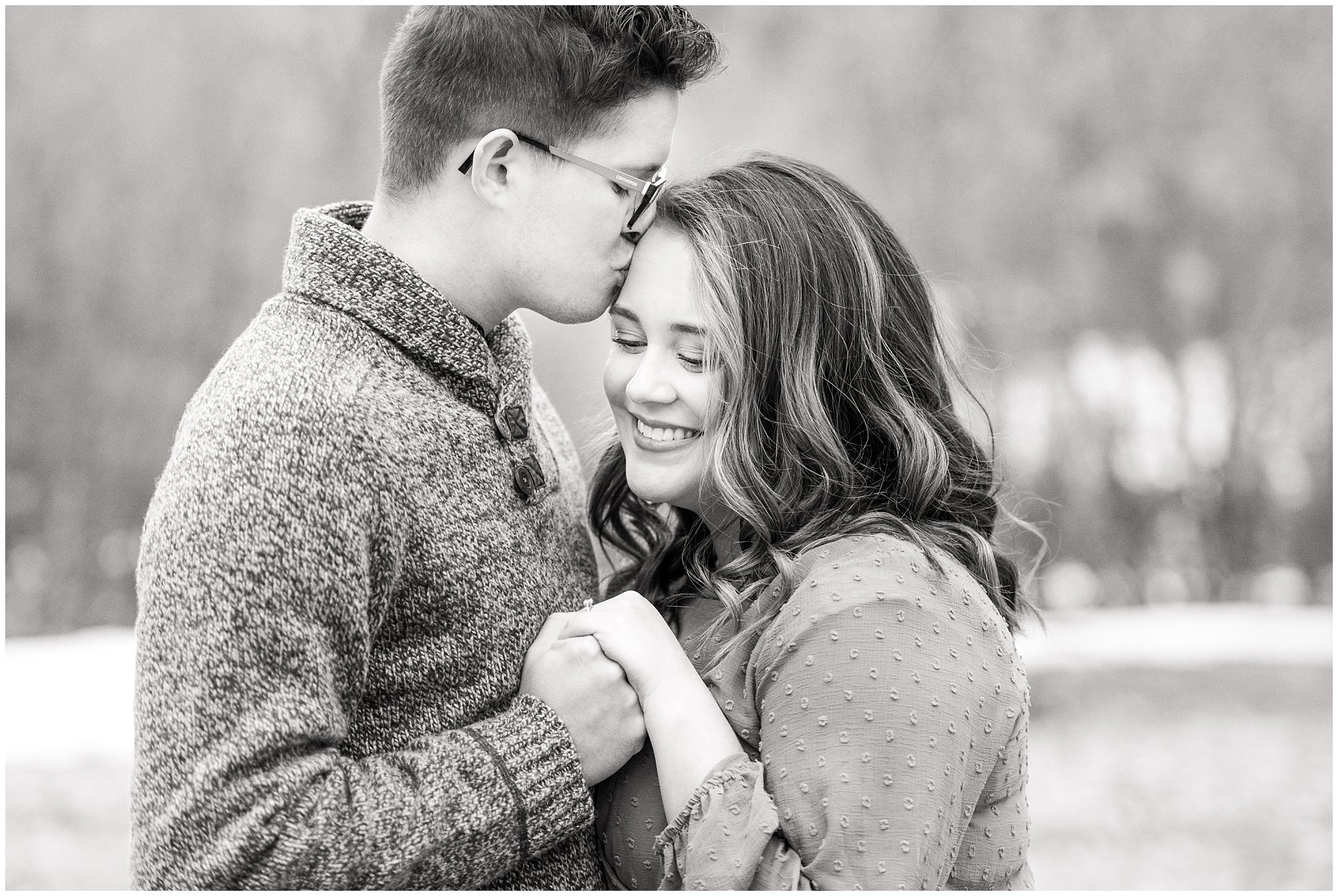 Couple in salmon colored dress and grey sweater during winter mountain engagements | Trapper's Loop Winter Engagement | Jessie and Dallin Photography