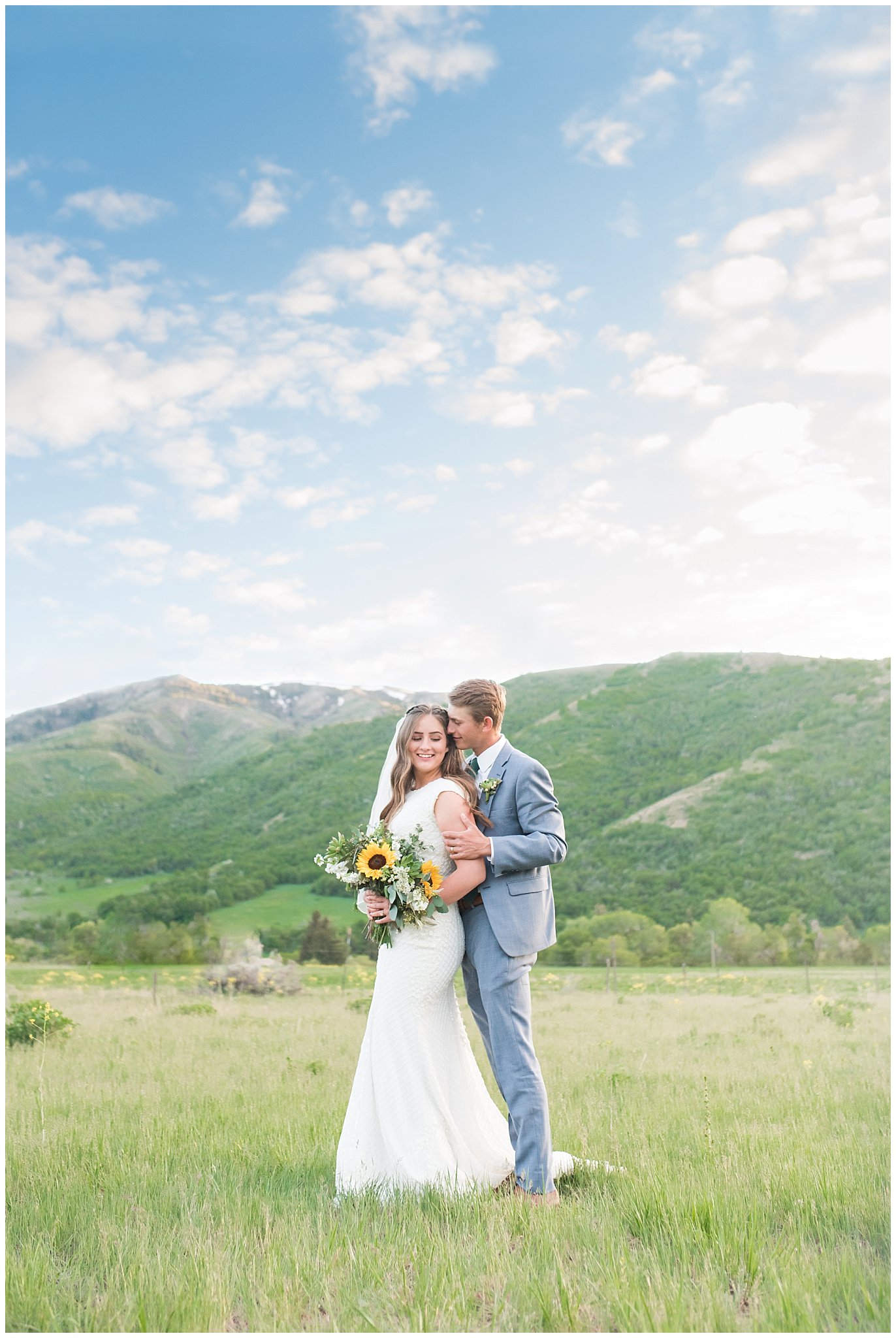 Bride with sunflower and succulent bouquet and groom in light blue suit in the mountains in Sardine Canyon Utah | Brigham City Temple and Mantua Mountain Formal Session | Jessie and Dallin Photography