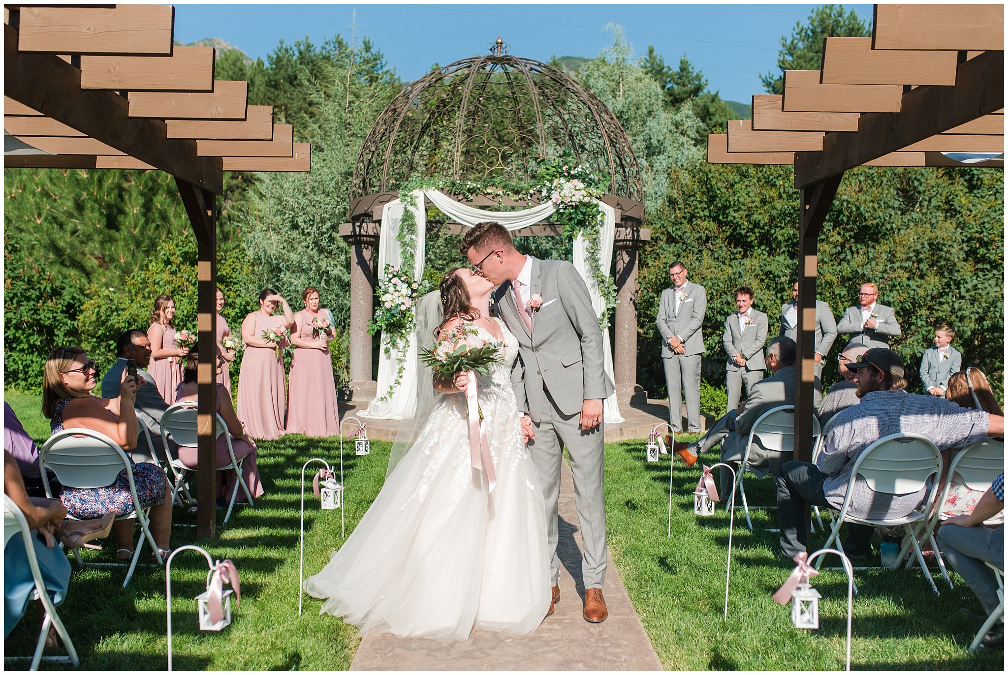 Bride and groom kiss during ceremony | Oak Hills Utah Dusty Rose and Gray Summer Wedding | Jessie and Dallin Photography