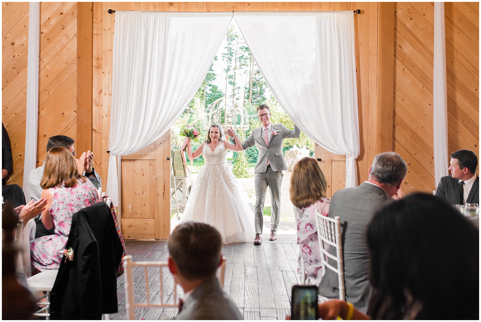 Bride and groom grand entrance in barn | Oak Hills Utah Dusty Rose and Gray Summer Wedding | Jessie and Dallin Photography