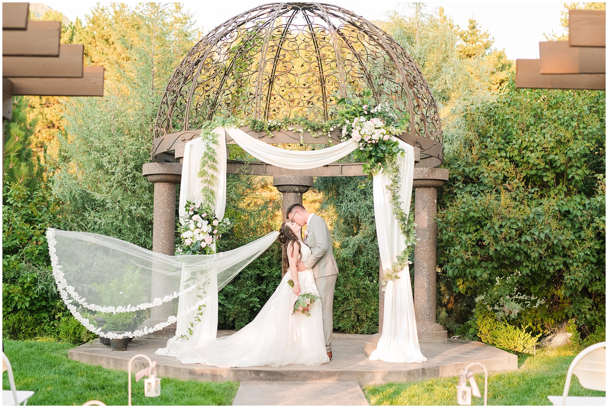 Bride and groom in gray suit with blush tie in front of the ceremony site arch | Oak Hills Utah Dusty Rose and Gray Summer Wedding | Jessie and Dallin Photography