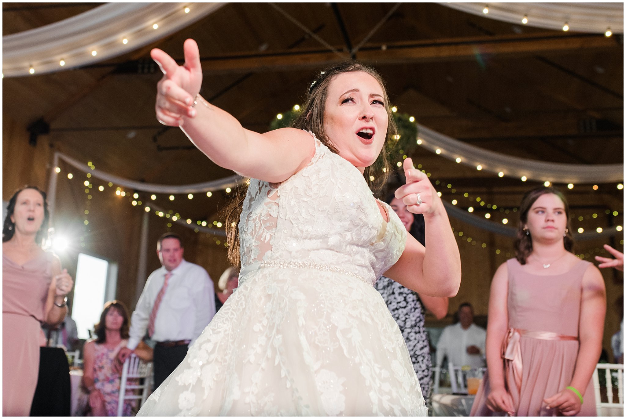 Bride busting a move during party dancing in barn | Oak Hills Utah Dusty Rose and Gray Summer Wedding | Jessie and Dallin Photography