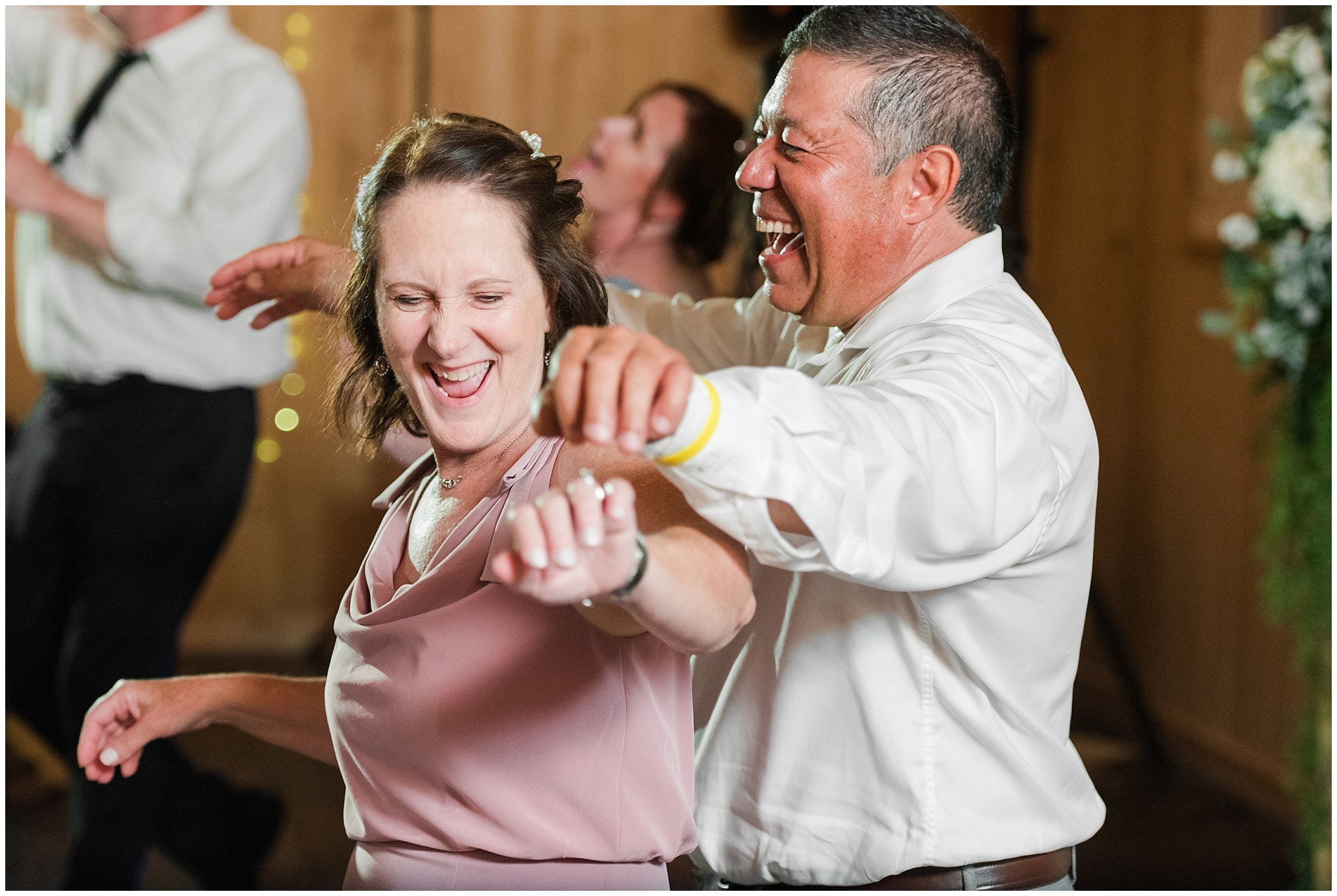 Parents busting a move during party dancing in barn | Oak Hills Utah Dusty Rose and Gray Summer Wedding | Jessie and Dallin Photography
