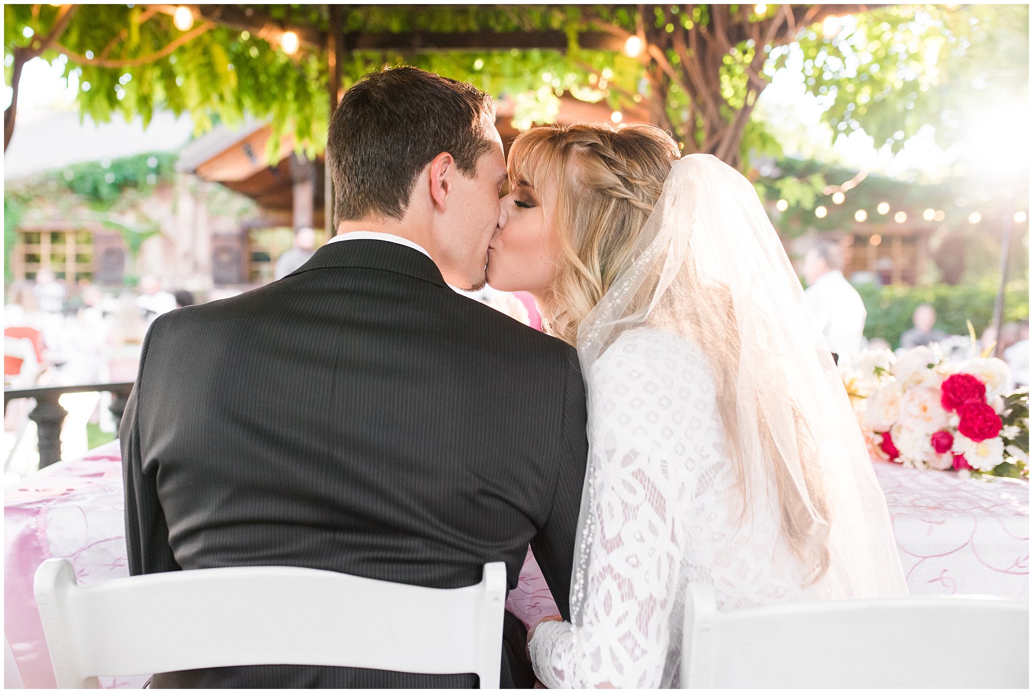 Bride and groom share a kiss at the sweethearts table | Wadley Farms Summer Wedding | Jessie and Dallin Photography