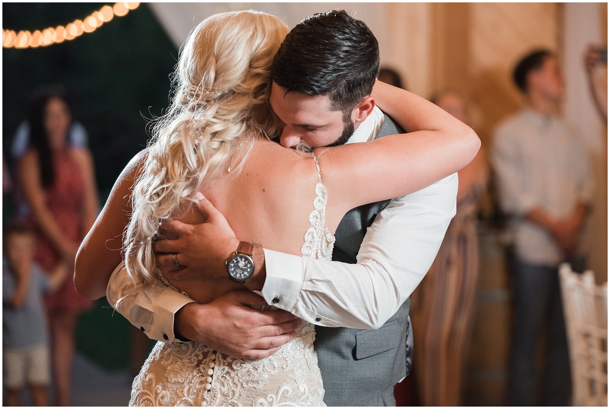 Bride and groom first dance in barn with lace dress and cathedral veil and gray suit with blue floral tie | Dusty Blue and Rose Summer Wedding at Oak Hills Utah | Jessie and Dallin Photography