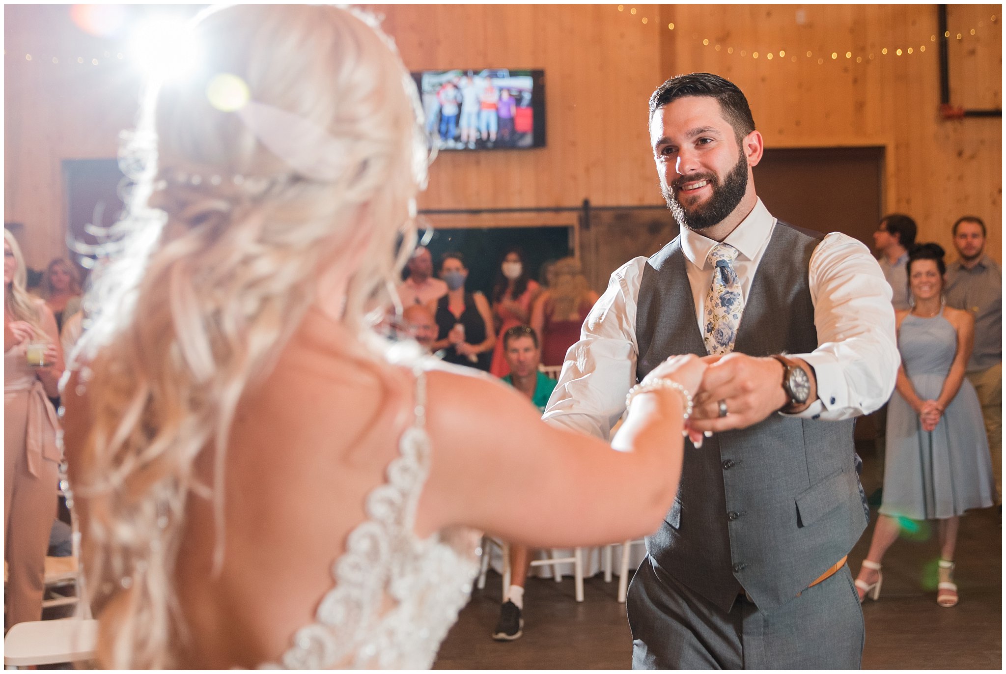 Bride and groom first dance in barn with lace dress and cathedral veil and gray suit with blue floral tie | Dusty Blue and Rose Summer Wedding at Oak Hills Utah | Jessie and Dallin Photography