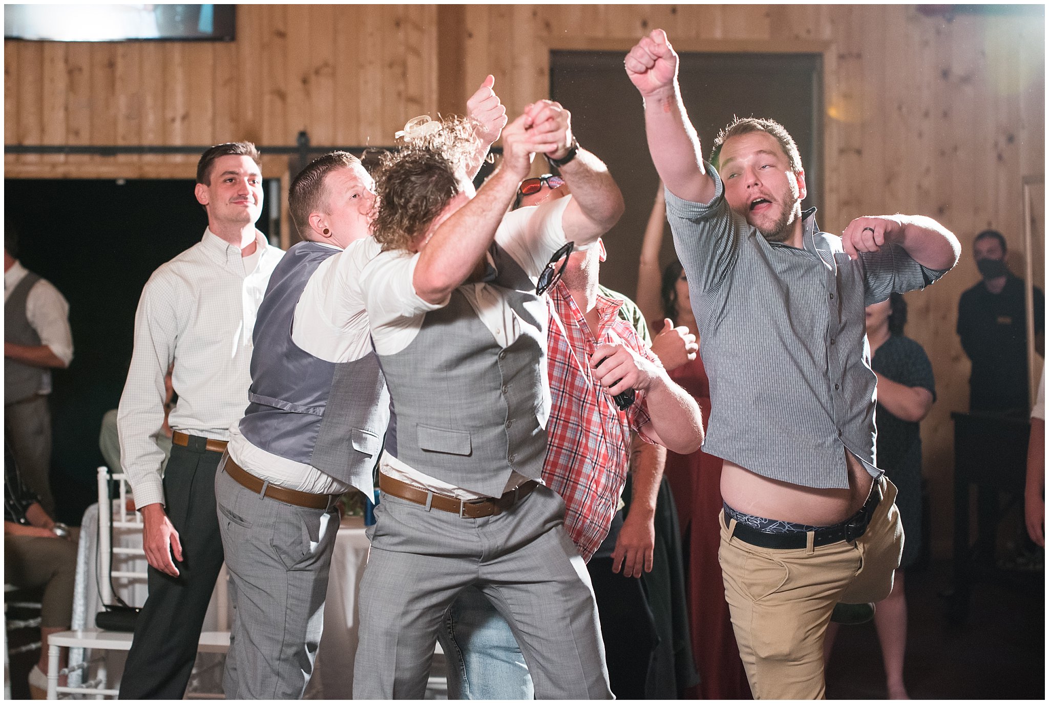 Garter toss in barn | Dusty Blue and Rose Summer Wedding at Oak Hills Utah | Jessie and Dallin Photography
