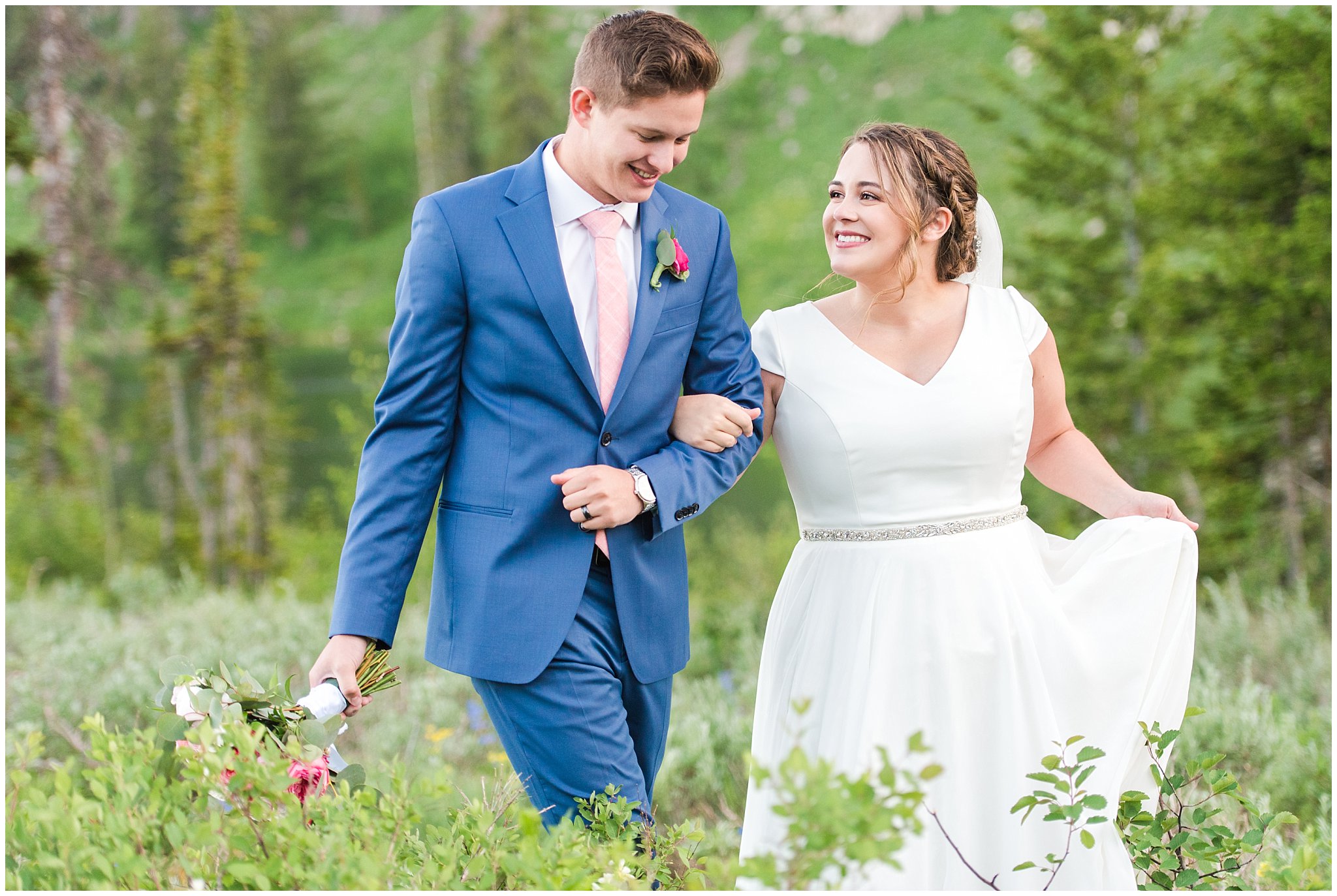 Bride and groom portraits in the Utah mountains wearing flowy wedding dress and cornish blue suit with pink and white florals | Summer Mountain wildflowers | Tony Grove Summer Formal Session | Jessie and Dallin Photography