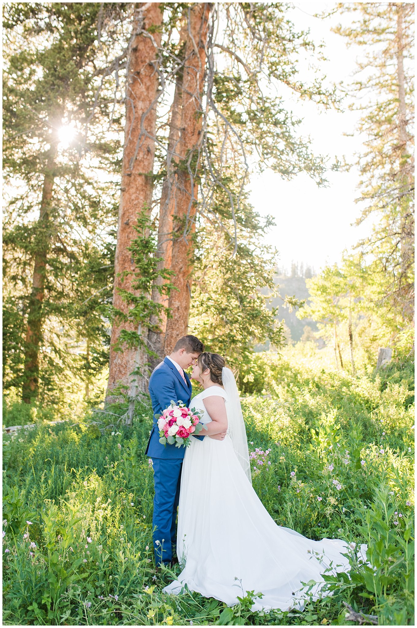 Bride and groom portraits in the Utah mountains wearing flowy wedding dress and cornish blue suit with pink and white florals | Summer Mountain wildflowers | Tony Grove Summer Formal Session | Jessie and Dallin Photography