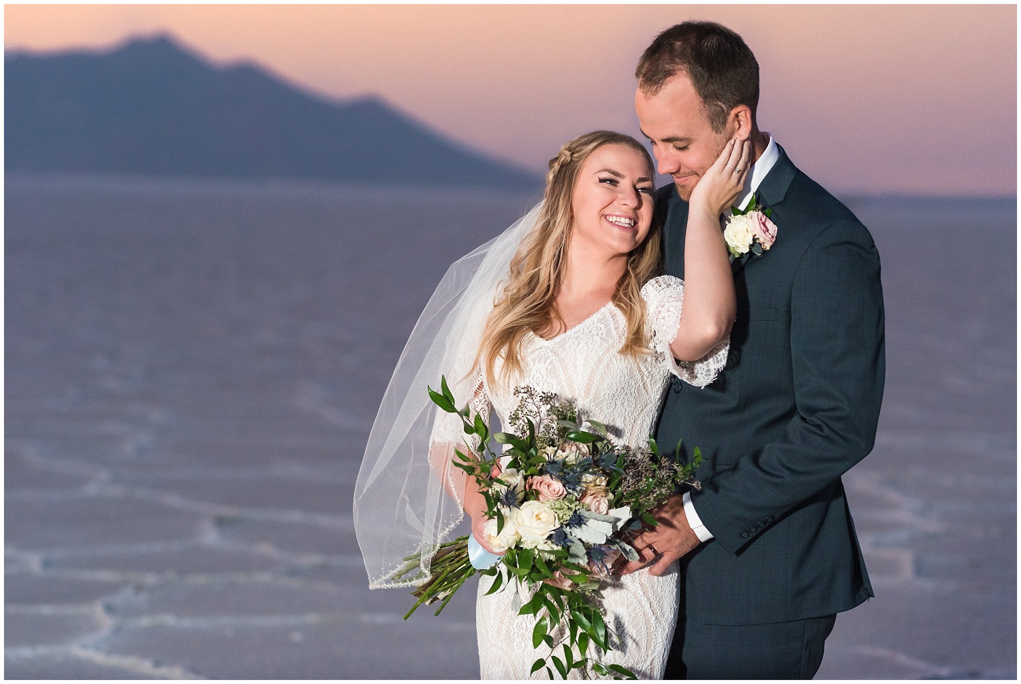 Bride and Groom at sunset in lace detail dress and blue suit for Adventure Session | Bonneville Salt Flats Sunset Wedding Formal Session | Jessie and Dallin Photography