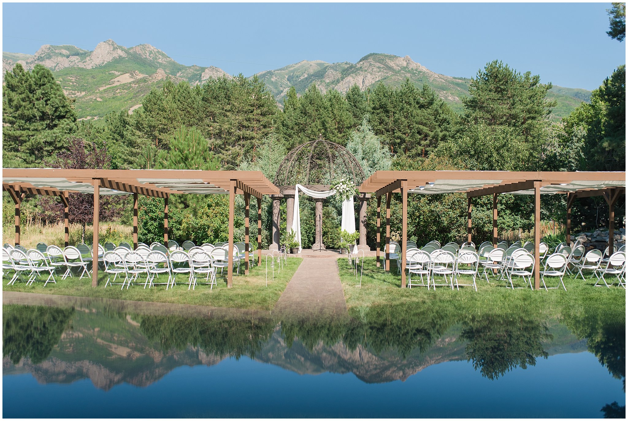 Ceremony site at Oak Hills with arch with white floral pieces | Sage Green and Gray Summer Wedding at Oak Hills | Jessie and Dallin Photography