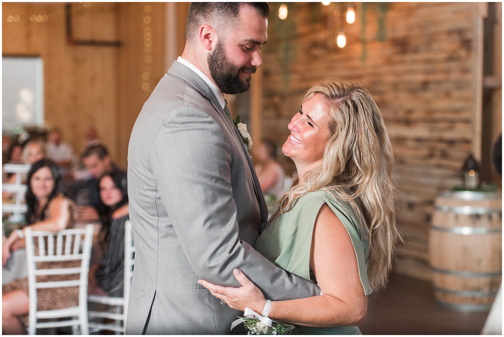 Mother son dance during Oak Hills wedding in the barn | Sage Green and Gray Summer Wedding at Oak Hills | Jessie and Dallin Photography
