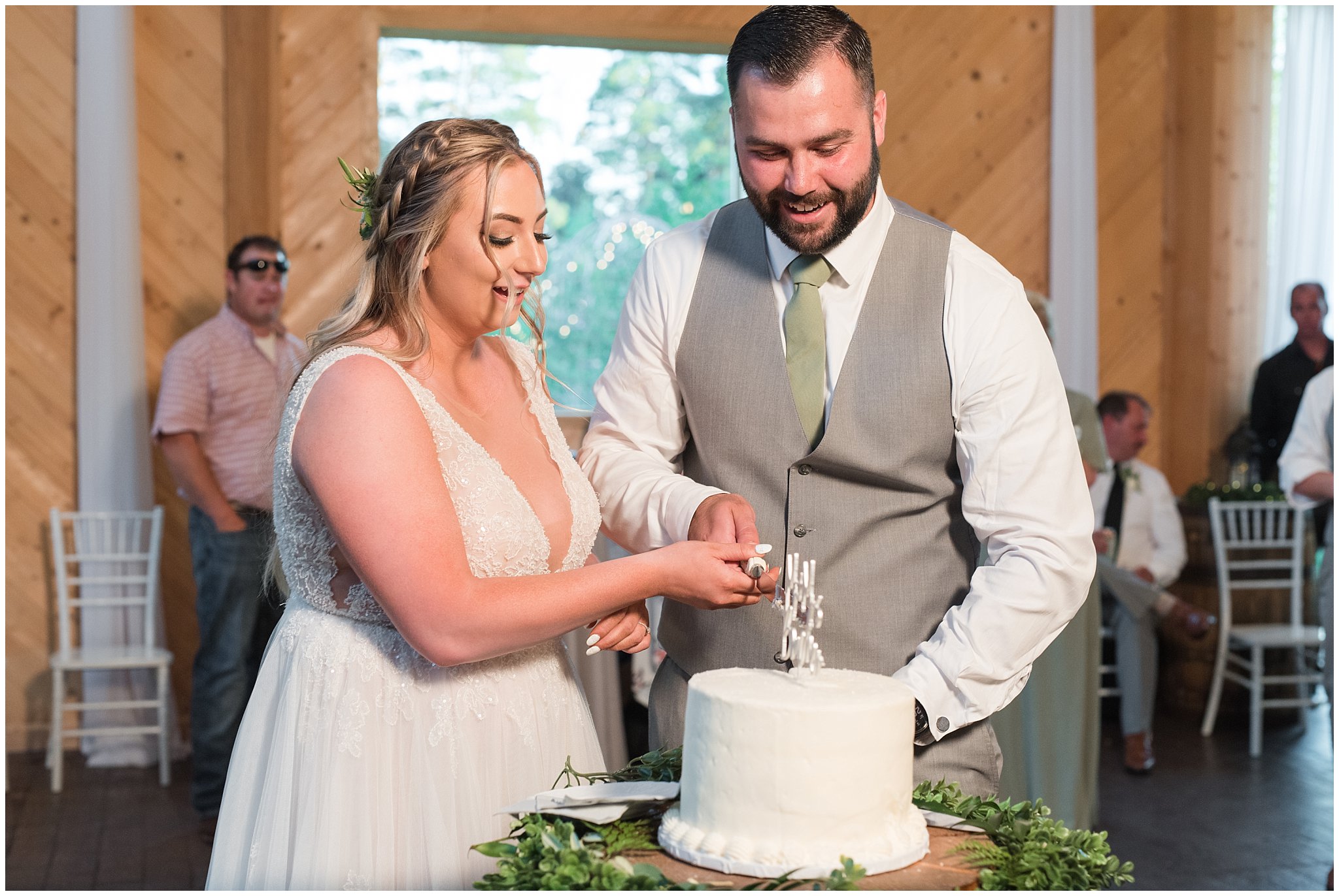 Cake cutting in bar with lots of emotion | Sage Green and Gray Summer Wedding at Oak Hills | Jessie and Dallin Photography