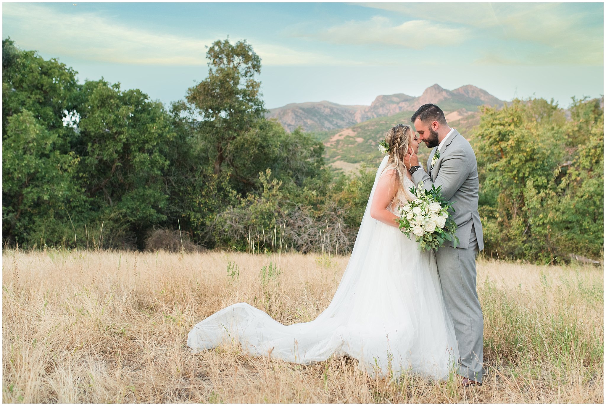 Bride and groom portraits with gray suit and champagne dress and veil and white floral bouquet in the Utah mountains | Sage Green and Gray Summer Wedding at Oak Hills | Jessie and Dallin Photography