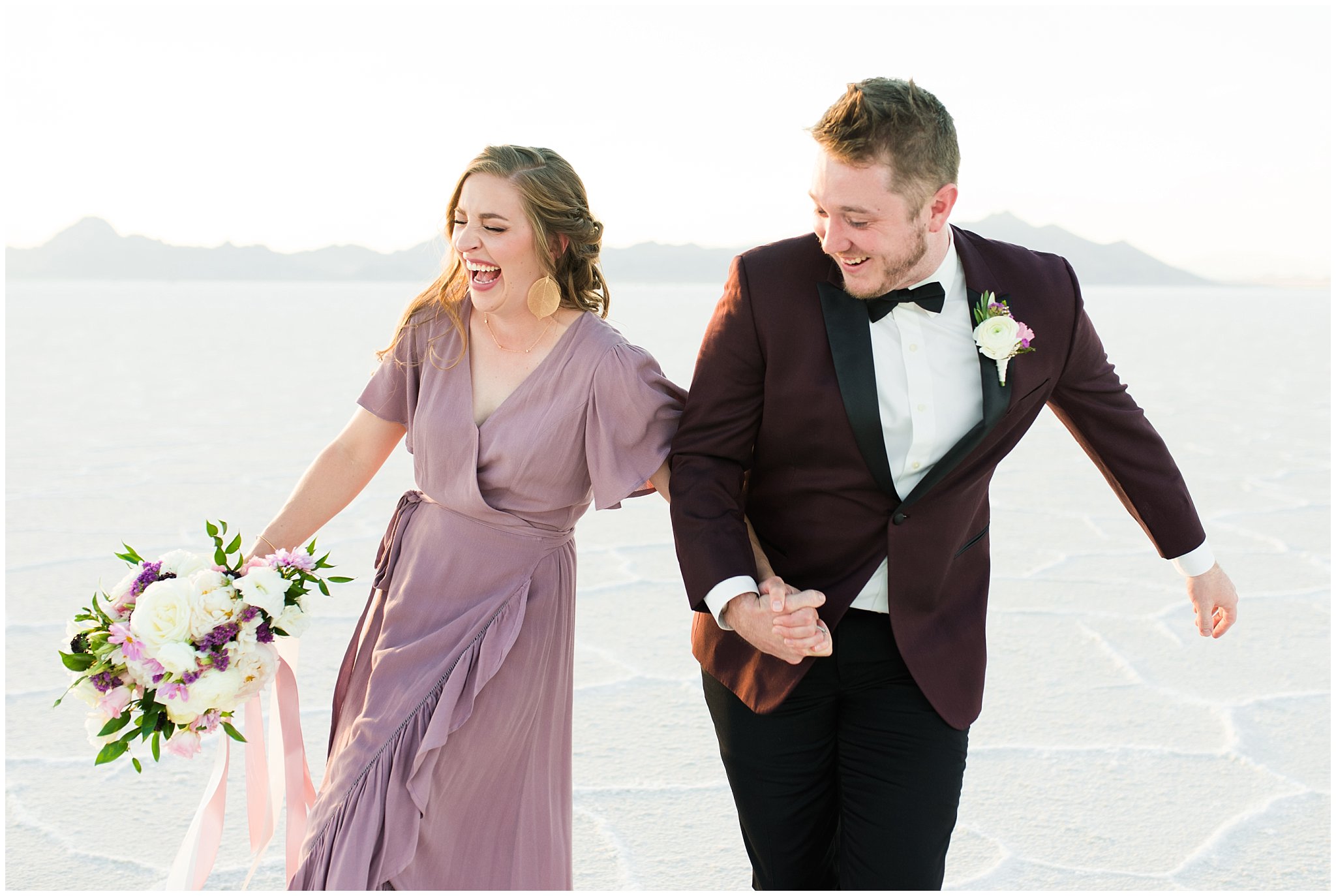Couple in dusty rose dress and burgundy suit with white and pink bouquet at the Bonneville Salt Flats Milky Way Anniversary Session | Jessie and Dallin Photography