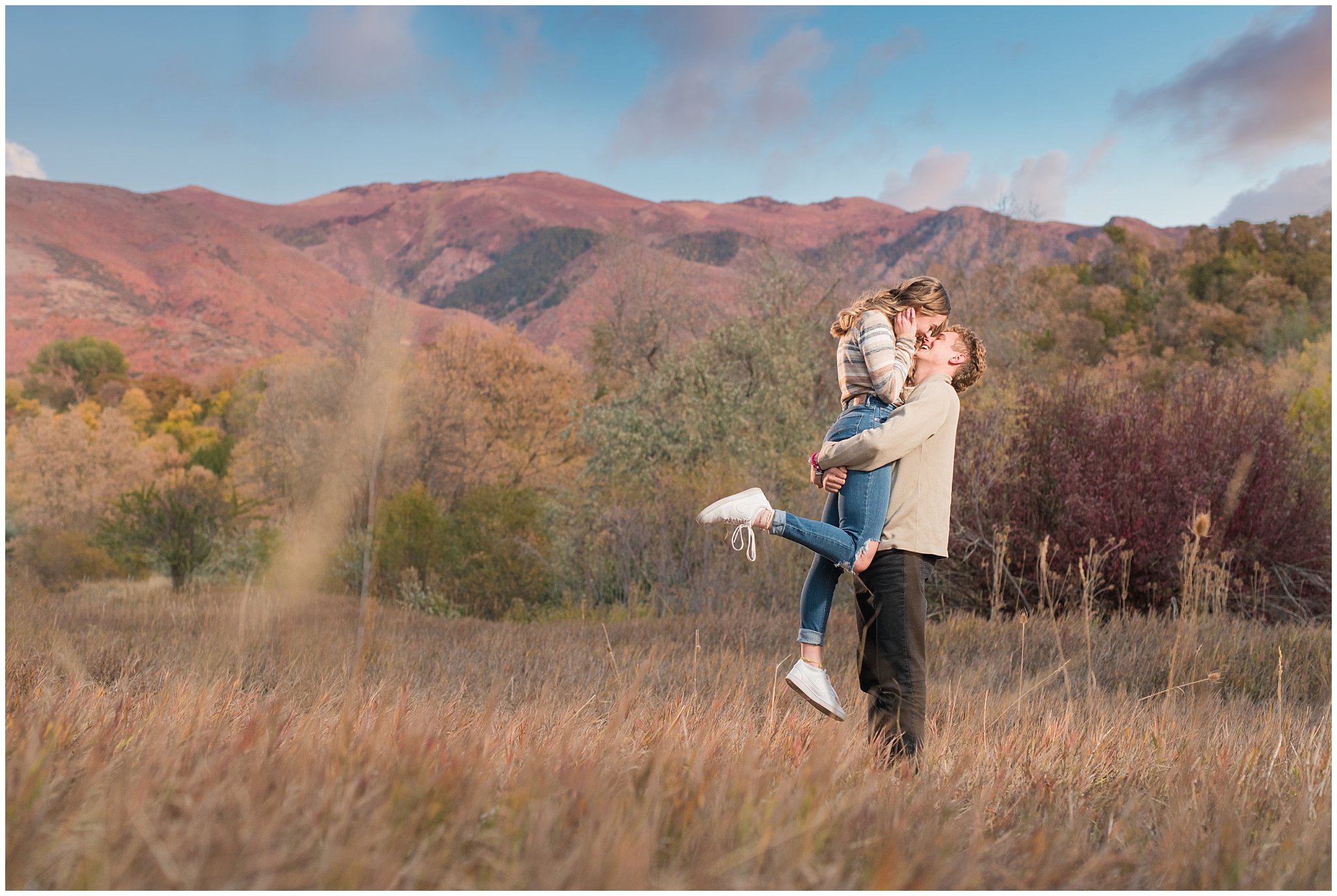 Candid photos of couple in casual cream colored fall sweaters with amazing sunset | Utah Fall Engagement Session in a Golden Field | Jessie and Dallin Photography