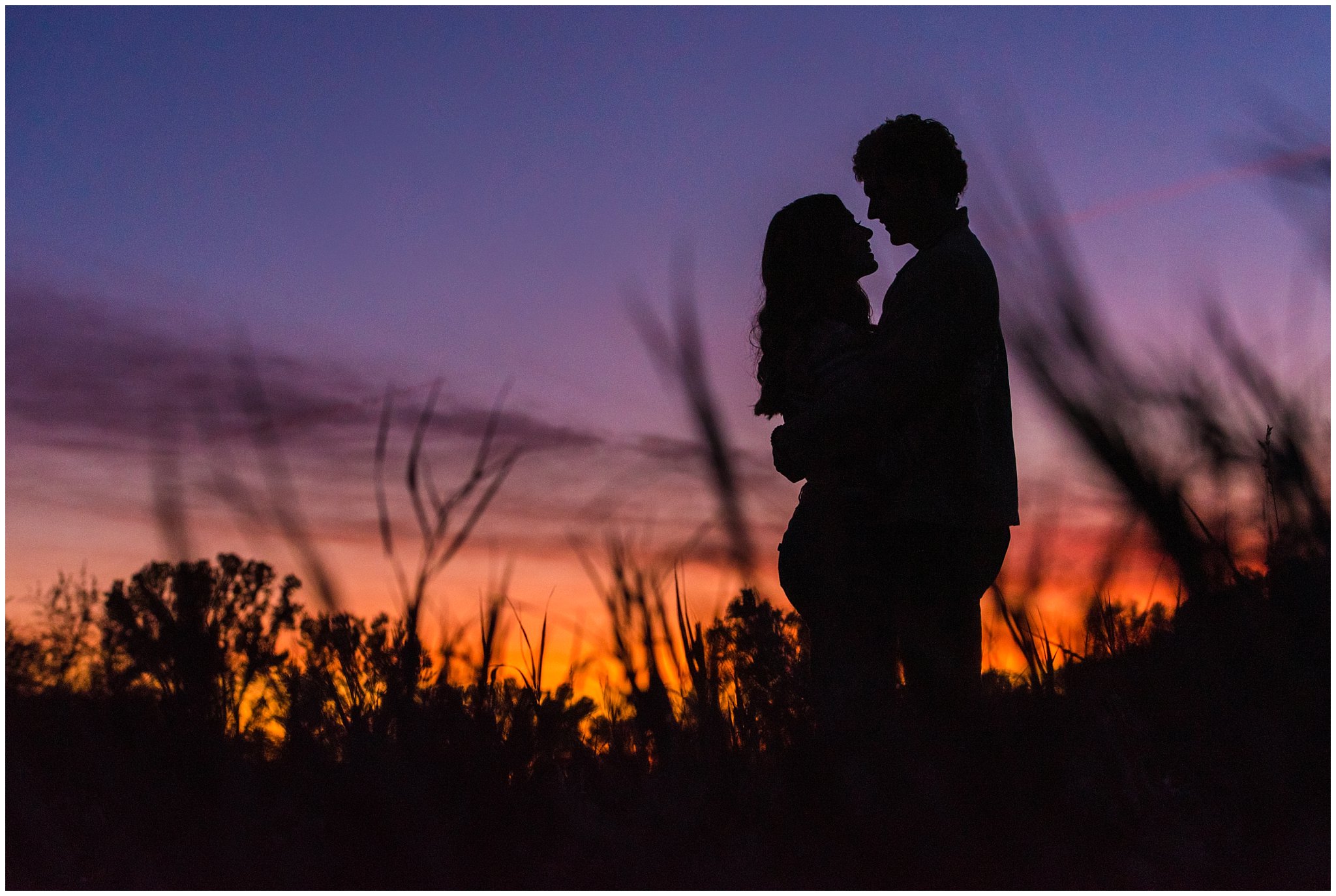 Candid photos of couple in casual cream colored fall sweaters with amazing sunset | Utah Fall Engagement Session in a Golden Field | Jessie and Dallin Photography