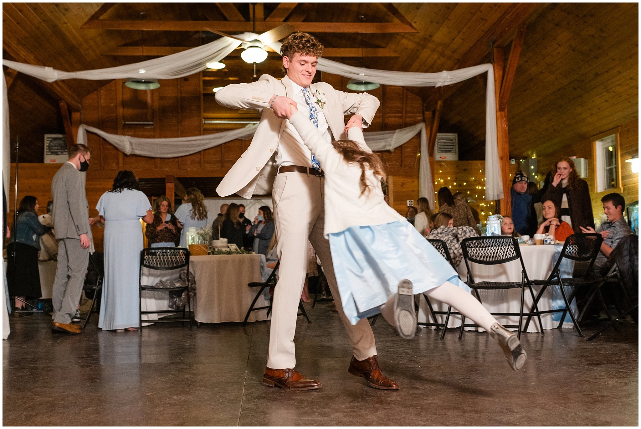 Group party dancing and laughing during barn wedding | Oquirrh Mountain Temple and Draper Day Barn Winter Wedding | Jessie and Dallin Photography