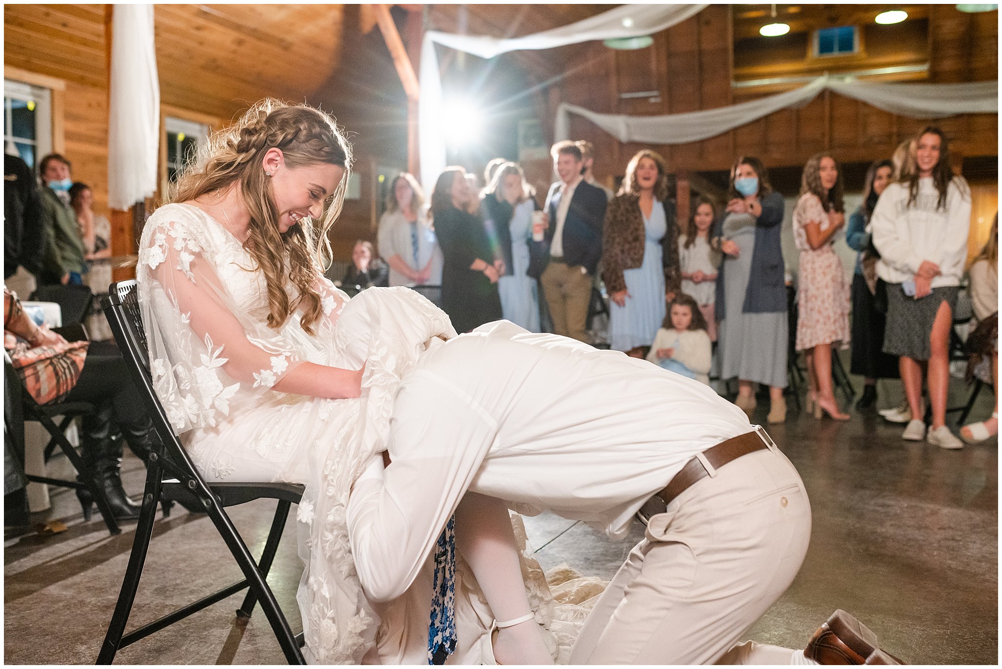 Garter toss during barn wedding | Oquirrh Mountain Temple and Draper Day Barn Winter Wedding | Jessie and Dallin Photography