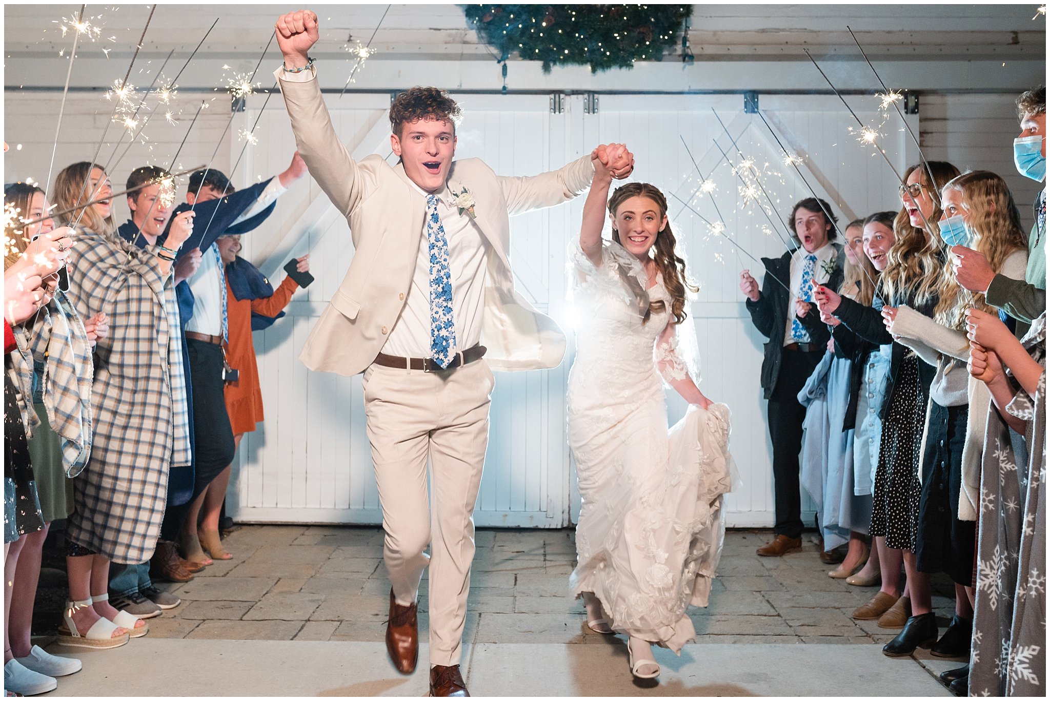 Fun and exciting sparkler exit during barn wedding | Oquirrh Mountain Temple and Draper Day Barn Winter Wedding | Jessie and Dallin Photography
